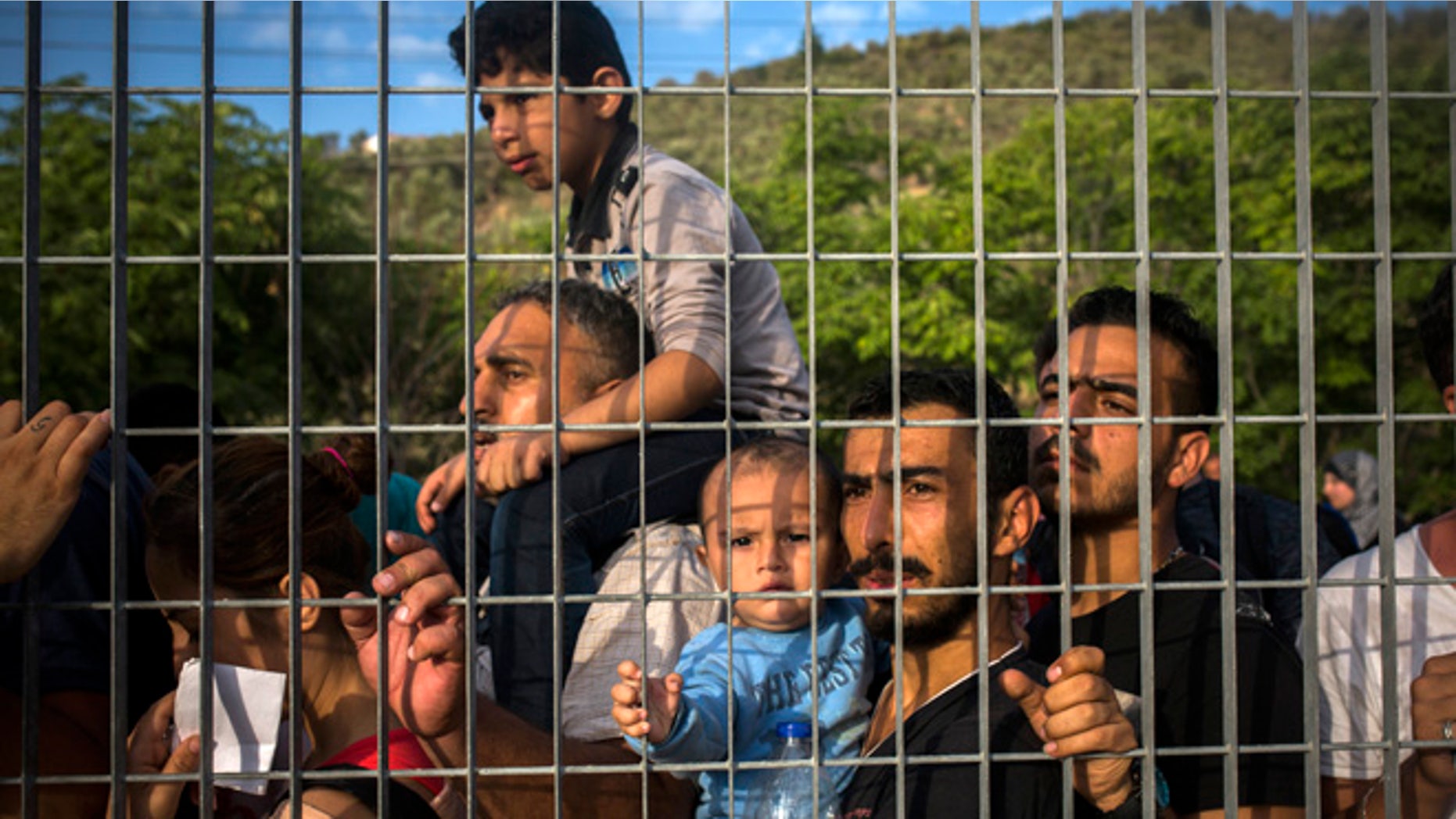 Sept. 8, 2015: Refugees and migrants wait for their registration and the issuing of travel documents at a soccer stadium in Mytilene, Greece.