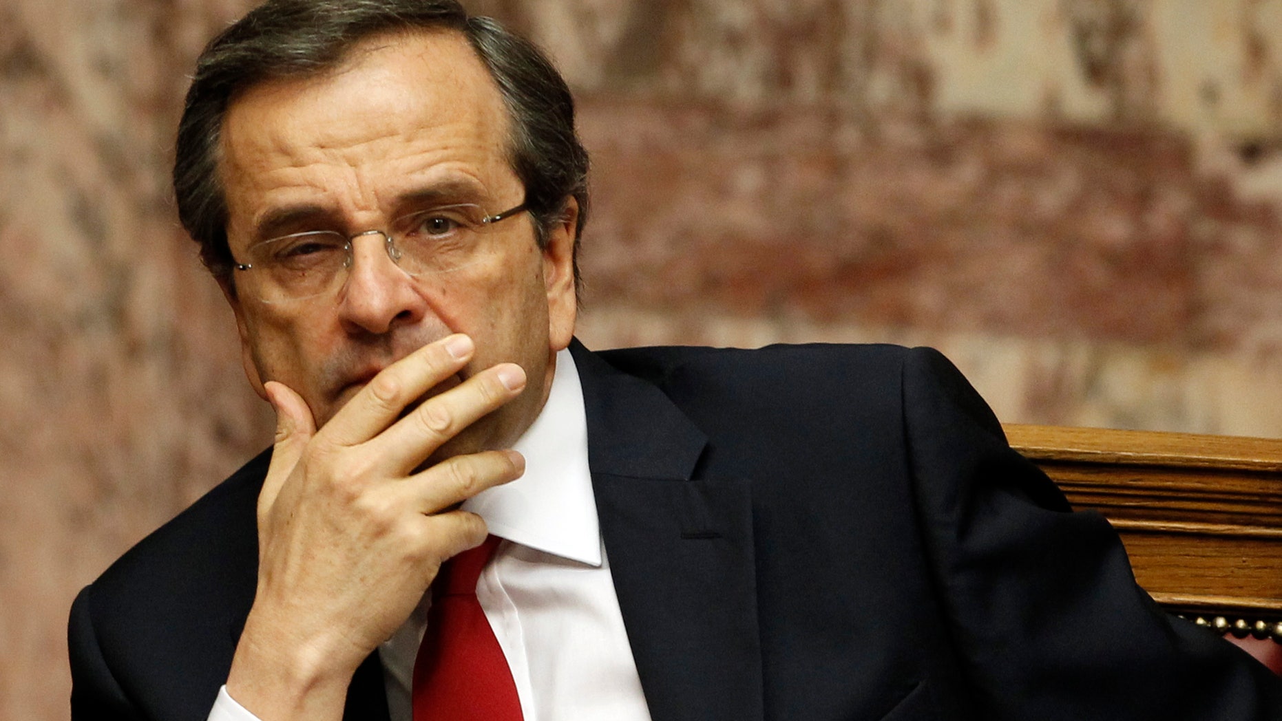 Greek Prime Minister Antonis Samaras looks on during a debate on the new government's policy agenda before staging a vote of confidence at the parliament in Athens, late Sunday July 8, 2012. (AP Photo/Kostas Tsironis)