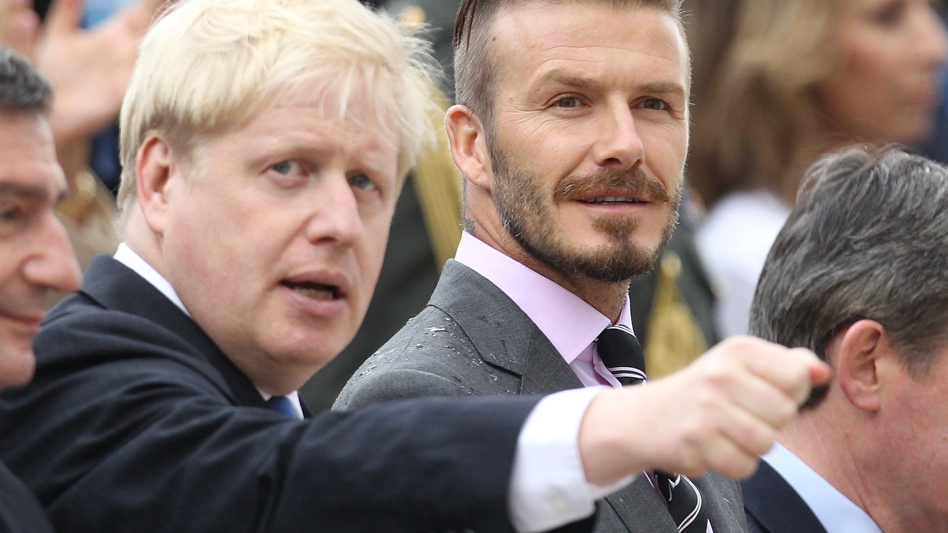 May 17, 2012: Former England football captain David Beckham, right, and London Mayor Boris Johnson attend a handover for the Olympic flame at Panathenaean stadium in Athens.