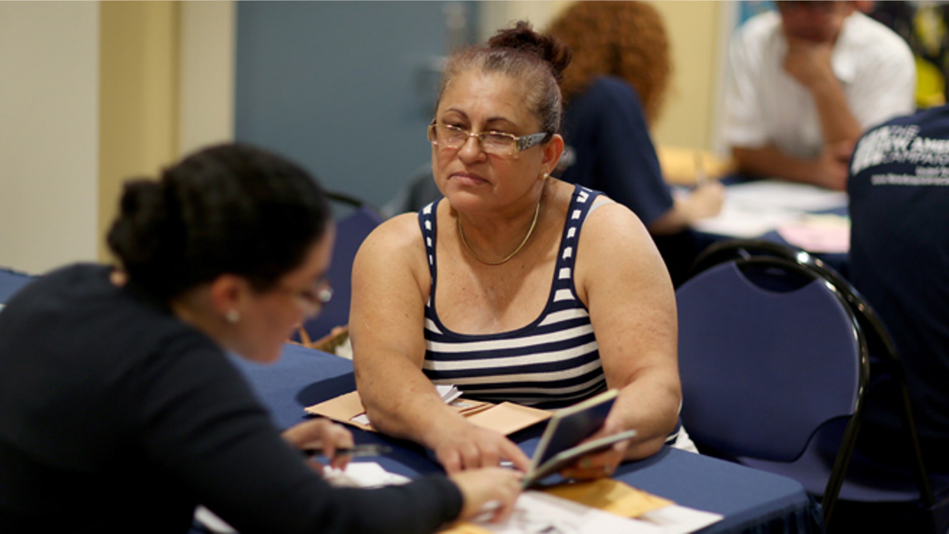 MIAMI, FL - SEPTEMBER 13: Gloria Lopez, originally from Nicaragua, sits with Jaclyn O'Connor, a Florida International University law school graduate, as she receives help in applying for United States citizenship September 13, 2014 in Miami, Florida. The clinic put on by the Florida New Americans (FNA) program, an initiative of the Florida Immigrant Coalition, provides legal assistance, study materials and information to Floridians applying for U.S. citizenship. Today, the program partnered with the Florida International University and Catholic Legal Services of the Archdiocese of Miami, to assist current eligible green-card holders with their citizenship application. (Photo by Joe Raedle/Getty Images)