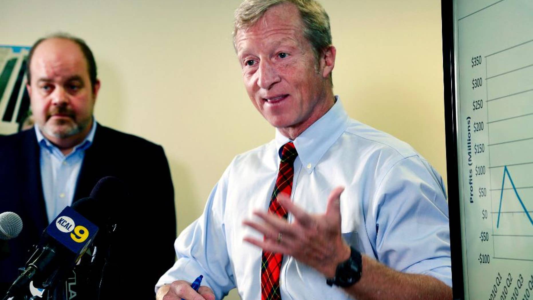 FILE - In this Aug. 5, 2015, file photo, billionaire climate activist Tom Steyer, right, speaks during a news conference with consumer advocate Jamie Court, left, president of Consumer Watchdog in Santa Monica, Calif. The Proposition 39 Citizens Oversight Board, tasked with overseeing projects funded by a California ballot measure intended to generate clean-energy jobs, is meeting for the first time on Tuesday, Sept. 8, 2015. (AP Photo/Nick Ut, File)