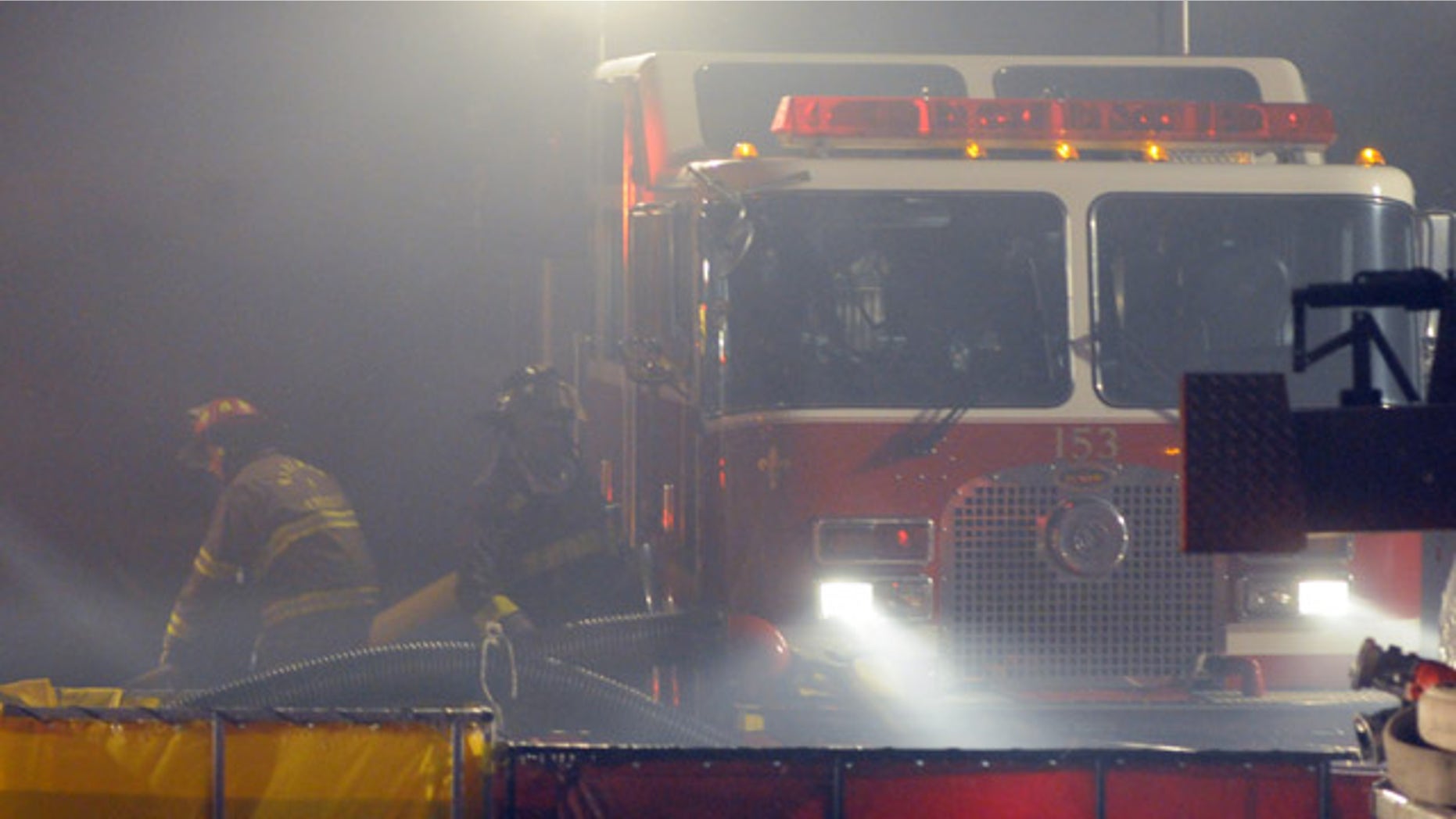 Feb. 19, 2013: Firefighters fill portable ponds with water to fight a large fire at Green Circle Growers Complex in Oberlin, Ohio.