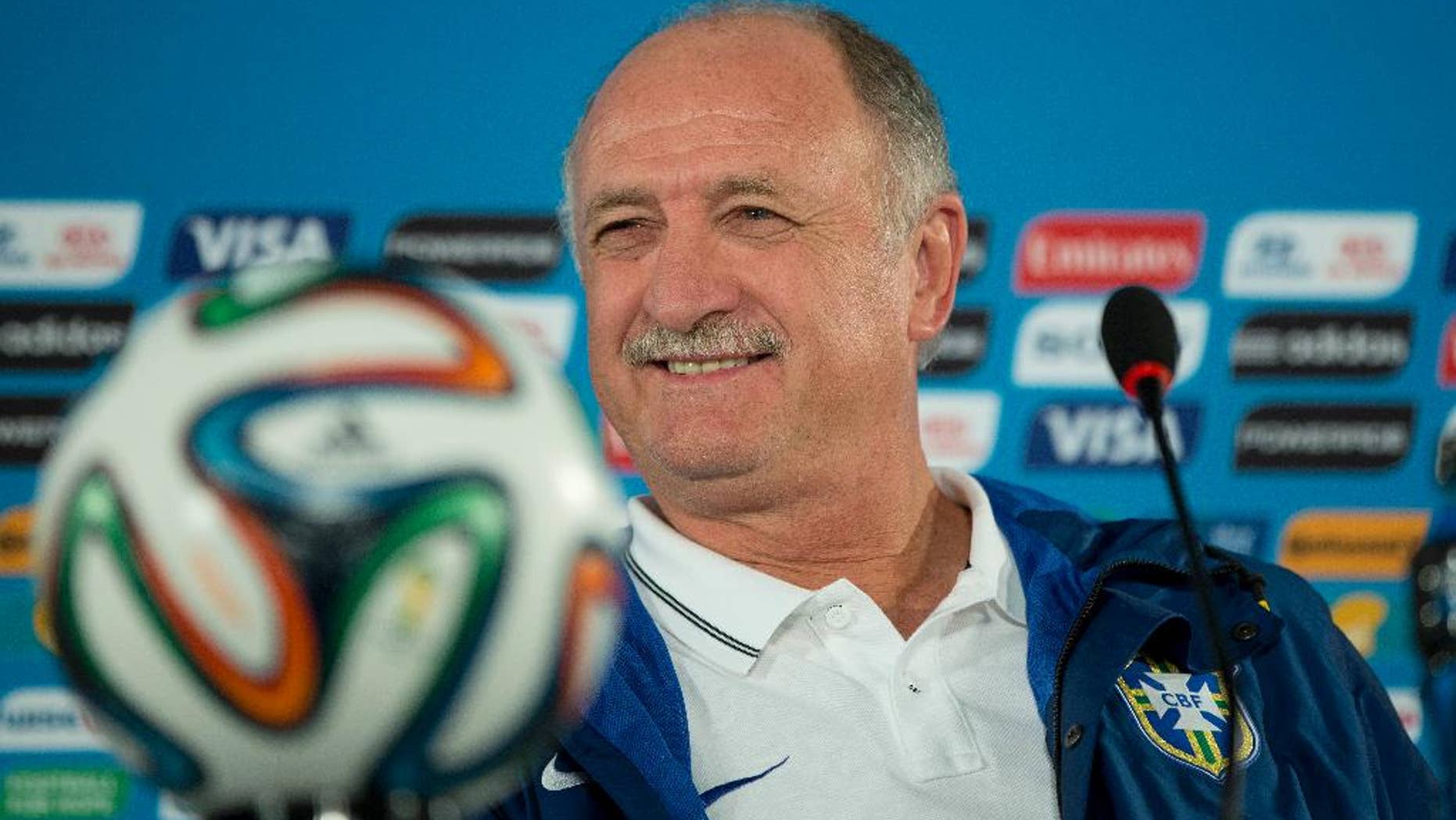 FILE - In this Friday, July 11, 2014 file photo, Brazil's coach Luiz Felipe Scolari smiles during a press conference a day before his team's World Cup third-place soccer match against the Netherlands at the Estadio Nacional in Brasilia, Brazil. Luiz Felipe Scolari, who resigned two weeks ago as Brazil coach, is returning to Gremio for his third stint in charge of the Brazilian team. The club confirmed the appointment on Tuesday July 29, 2014. Scolari first coached the club in 1987 and returned six years later for another stint. (AP Photo/Andre Penner, File)
