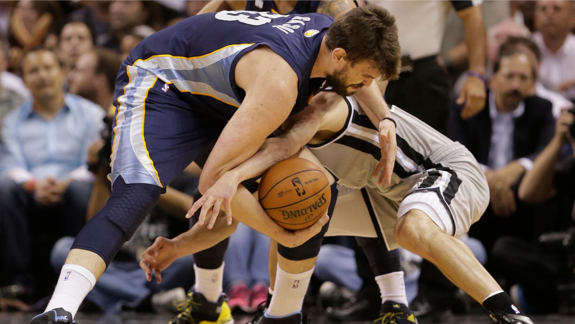 Memphis Grizzlies' Marc Gasol, left, and San Antonio Spurs' Manu Ginobili, of Argentina, during the first half in Game 2 of the Western Conference finals NBA basketball playoff series, May 21, 2013, in San Antonio.