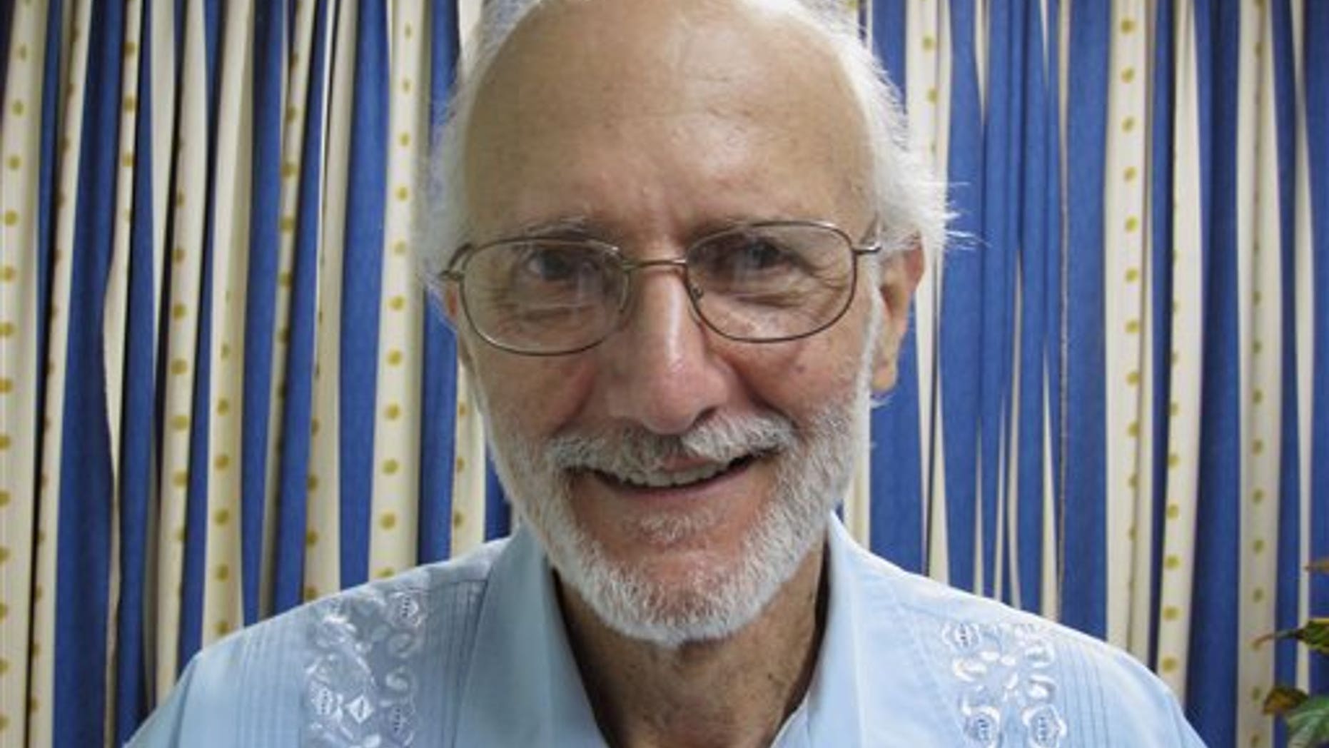 In this file photo provided by U.S. lawyer James L. Berenthal, jailed American Alan Gross poses for a photo during a visit by Rabbi Elie Abadie and Berenthal at Finlay military hospital in Havana, Cuba.