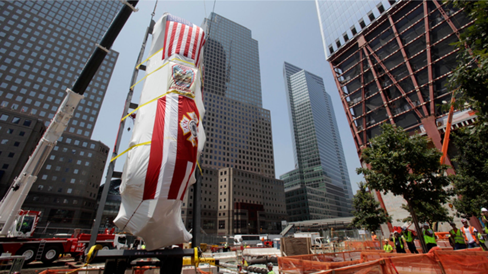 July 20: The Fire Department of New York's Ladder Company 3 fire truck is lowered by crane into the National September 11 Memorial Museum.