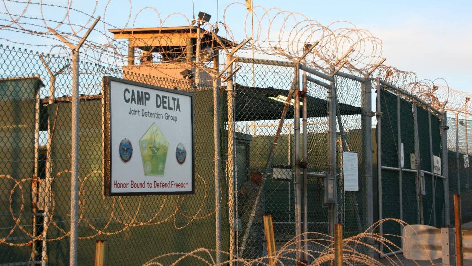 FILE - This Oct. 24, 2010, file photo shows the entrance to Camp Delta at Guantanamo Bay. Six men long held at Guantanamo Bay arrived Saturday, June 13, 2015, in Oman, the first movement of detainees out of the U.S. prison for terrorism suspects in five months as Congress considers new restrictions on transfers. The six detainees — all from Oman's war-torn Mideast neighbor Yemen — boarded a flight from the U.S. prison in Cuba on Friday, bringing Guantanamo's population down to 116. The move means President Barack Obama has now transferred more than half of the 242 detainees who were at Guantanamo when he was sworn into office after campaigning to close it. (AP Photo/The Canadian Press, Colin Perkel)
