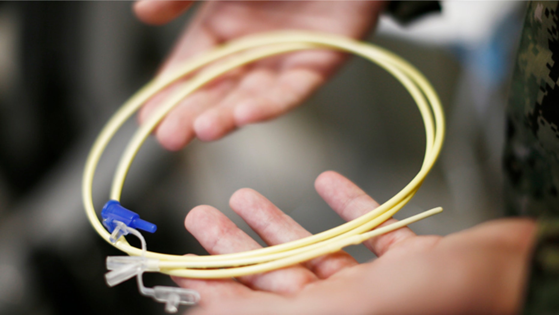 Nov. 20, 2013: In this photo, reviewed by the U.S. military, U.S. Navy medical personnel displays an enteral feeding tube, used for force-feeding detainees, during a tour of the detainee hospital at Guantanamo Bay Naval Base, Cuba.