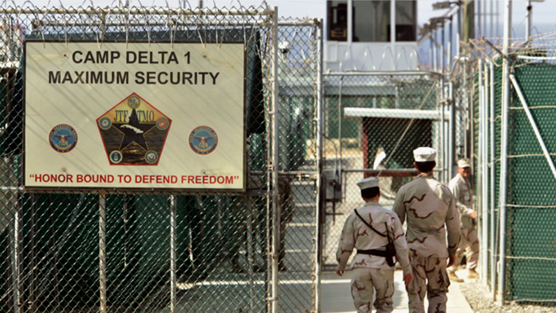 FILE: 2006: U.S. military guards walk within Camp Delta military-run prison, at the Guantanamo Bay U.S. Naval Base, Cuba.