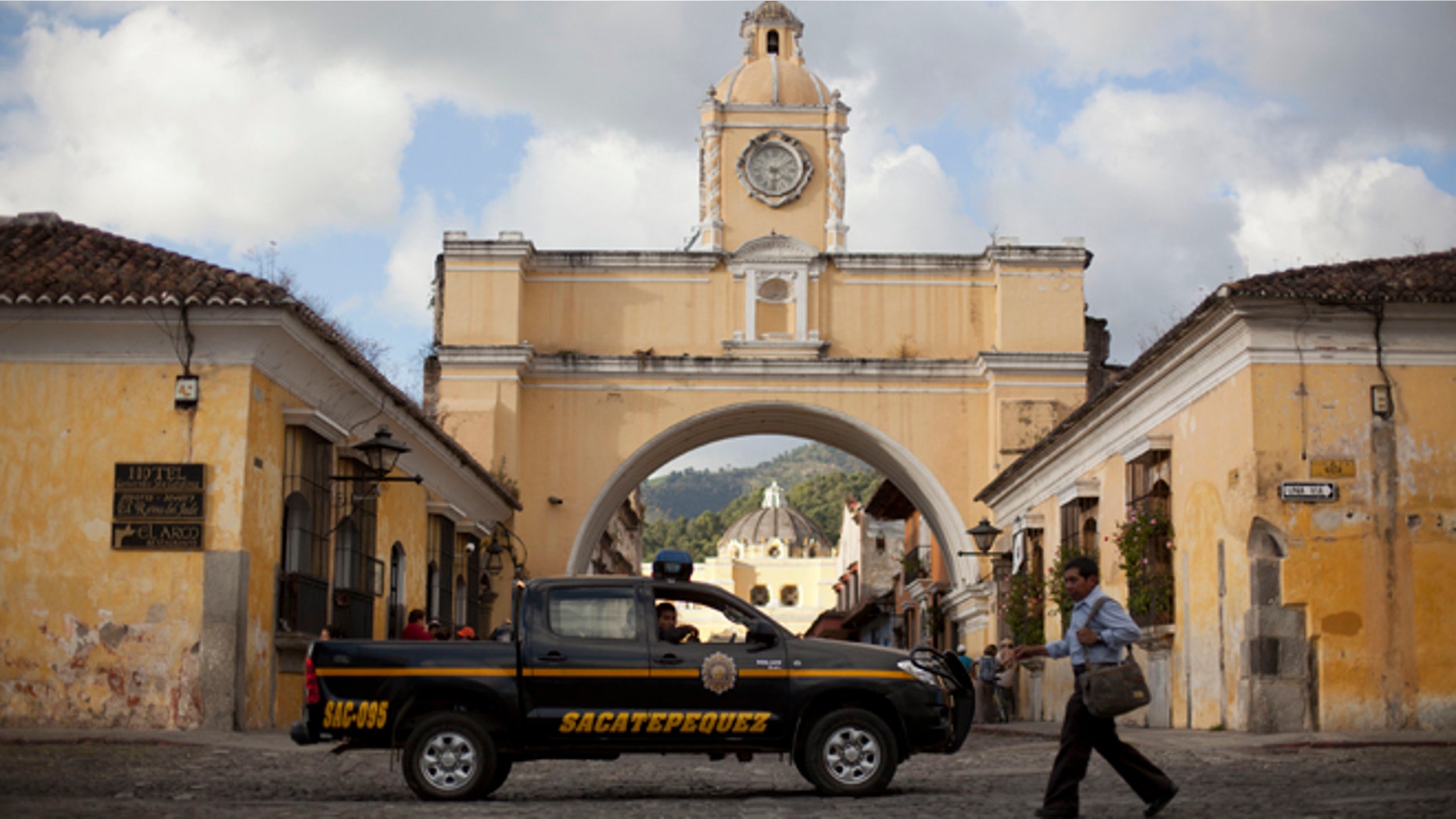In this Nov. 14, 2013 photo, police patrol along a main street close to the Santa Catalina convent in Antigua, Guatemala. Vehicle and home burglaries are up, and once-reliable public services such as water and trash collection have been left unattended across whole blocks. (AP Photo/Luis Soto)