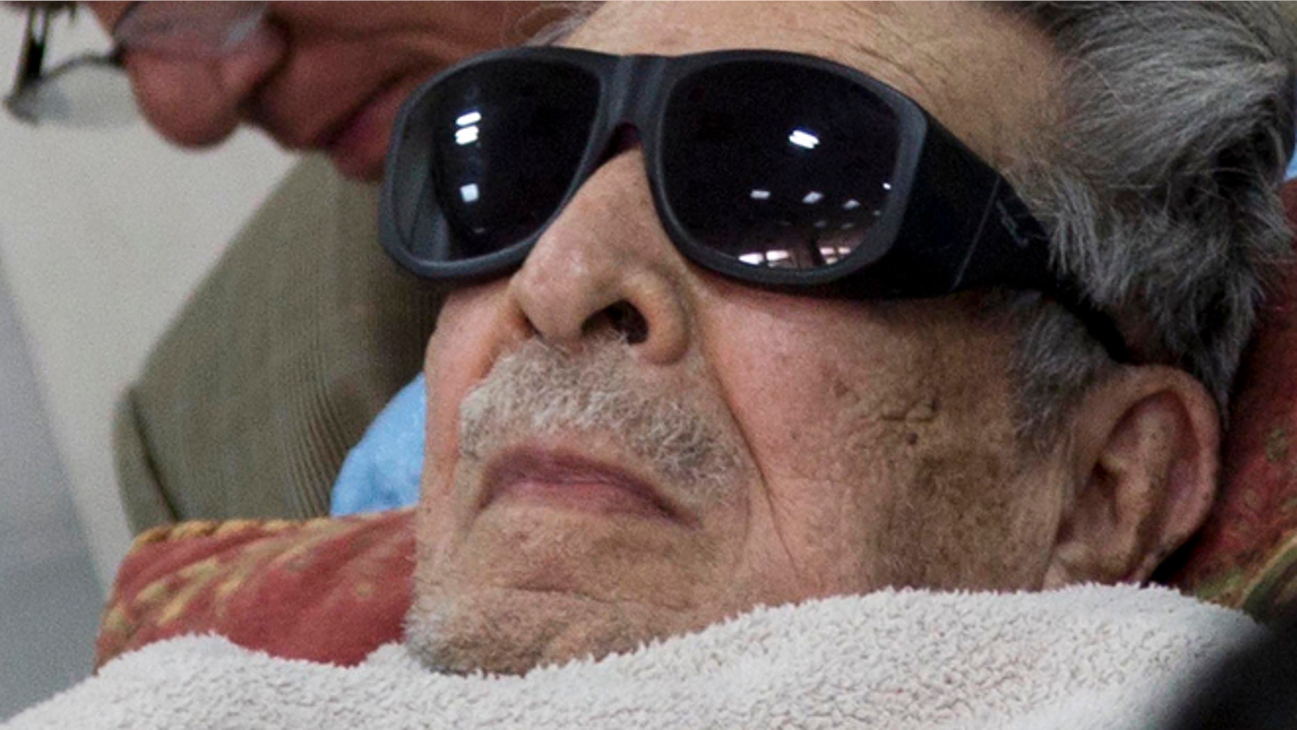 FILE - In this Jan. 5, 2015 file photo, Guatemala's former dictator Jose Efrain Rios Montt arrives on a gurney wearing sunglasses to court where he faces charges of genocide and crimes against humanity in Guatemala City. A Guatemalan court ordered on Thursday, July 23, 2015, Rios Montt be put in a psychiatric hospital for nine days observation, delaying his possible retrial on genocide charges. The court order seeks to evaluate the 89-year-old ex-general's mental and physical health following a report that found him incompetent to stand trial. (AP Photo/Luis Soto, File)