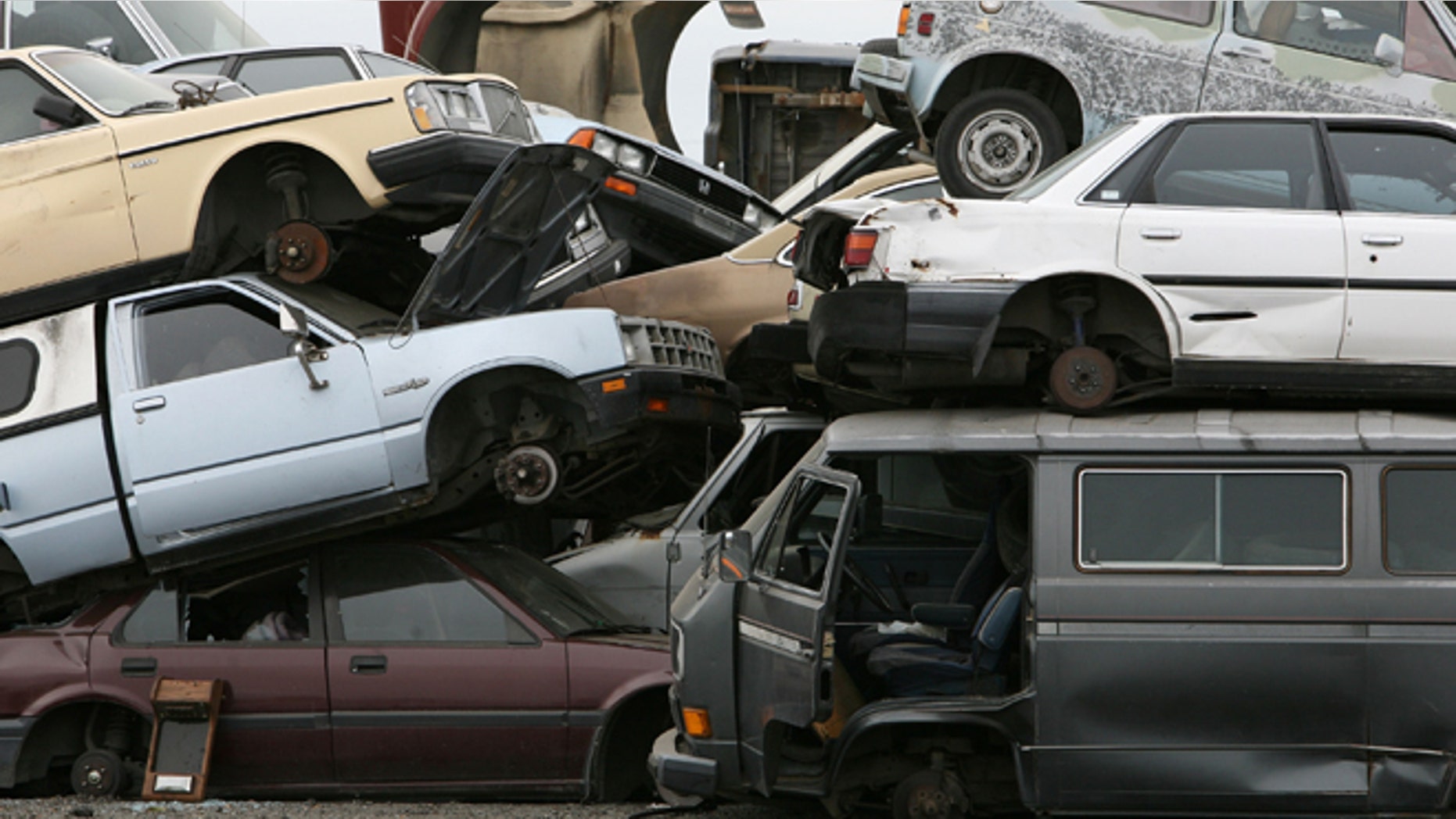RICHMOND, CA - JULY 31: Junk cars are seen stacked at Deal Auto Wrecking July 31, 2009 in Richmond, California. Federal lawmakers are seeking an additional $2 billion to keep the popular "Cash For Clunkers" program going after the initial $1 billion in funding ran out after a week. (Photo by Justin Sullivan/Getty Images)