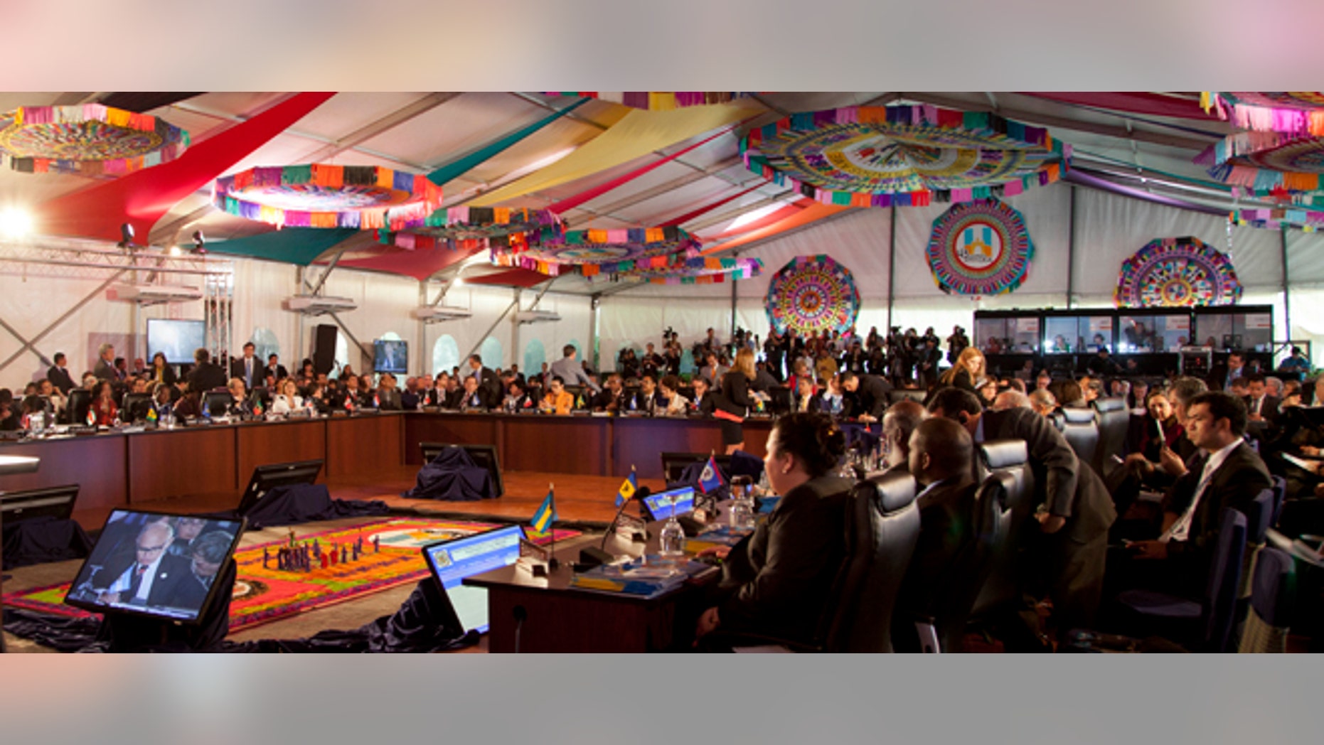 Delegates meet for the first session of the 43rd General Assembly of the Organization of American States, OAS, in Antigua Guatemala, Guatemala, Wednesday, June 5, 2013. Latin American countries frustrated by the United States' refusal to change its drug war strategy will push at the OAS conference that began Tuesday for the U.S. government to start discussing alternative approaches to a fight that has killed tens of thousands in a region beset by drug cartels. (AP Photo/Moises Castillo)