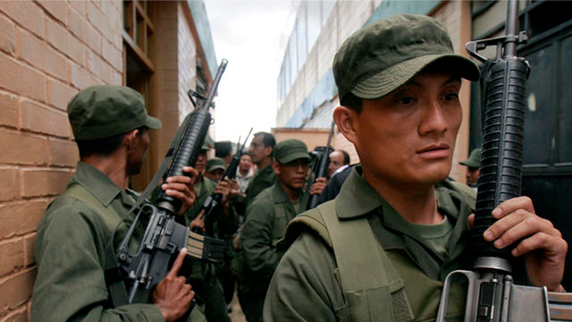 Soldiers patrol the entrance to the "Pavon" prison in Fraijanes, Guatemala, Monday, Sept. 25, 2006. More than 3,000 police and soldiers stormed a prison housing many of Guatemala's most-feared criminals on Monday, touching off a fierce and chaotic battle in which at least eight inmates died. (AP Photo/Moises Castillo)
