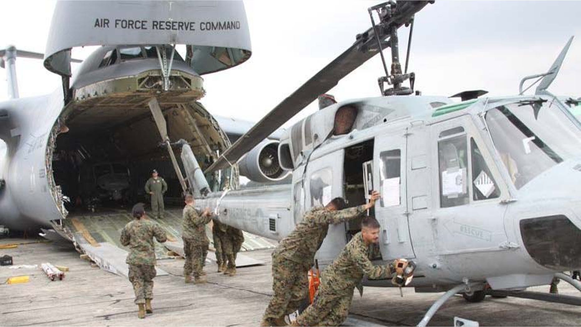 In this image released by the U.S. Marine Corps on Wednesday Aug. 29, 2012, Marines from Marine Light Attack Helicopter Squadron 467 (HMLA-467) unload a UH-1N Huey helicopter in Guatemala City, Aug. 11, 2012. A team of 200 U.S. Marines and four UH-1N Huey helicopters has begun patrolling Guatemalaâs western coast this week in what a military spokesman says is an unprecedented operation, code named Operation Martillo, to beat drug traffickers in the Central America region. (AP Photo/U.S. Marine Corps)