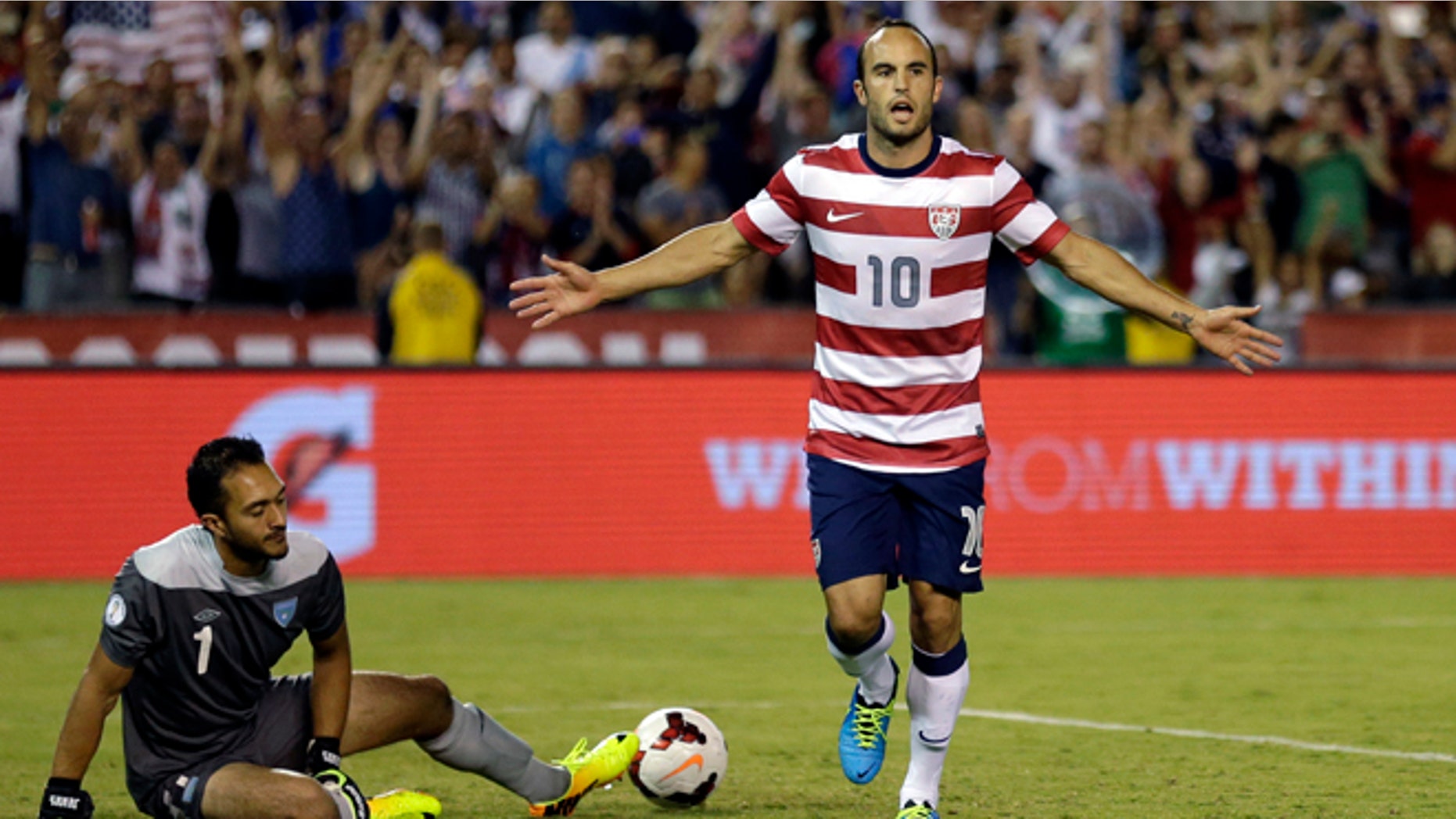 The United States' Landon Donovan, right, reacts after scoring on a penalty kick as Guatemala's goalkeeper Ricardo Jerez gets up at left in the second half during an international friendly soccer match Friday, July 5, 2013, in San Diego. (AP Photo/Gregory Bull)