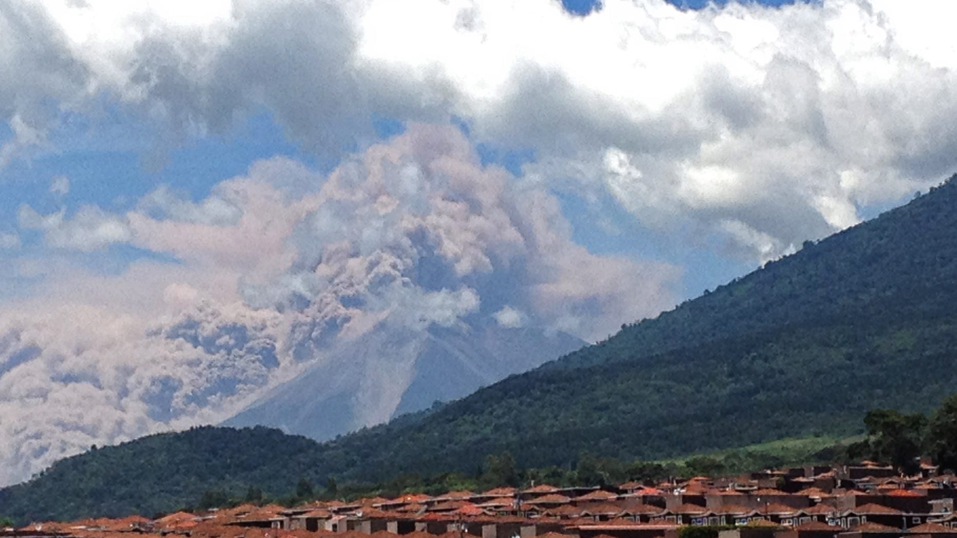 Sept. 13, 2012: In this image with a cell phone plumes of smoke rise from the Volcan de Fuego or Volcano of Fire spews ash seen from Palin, south of Guatemala City.
