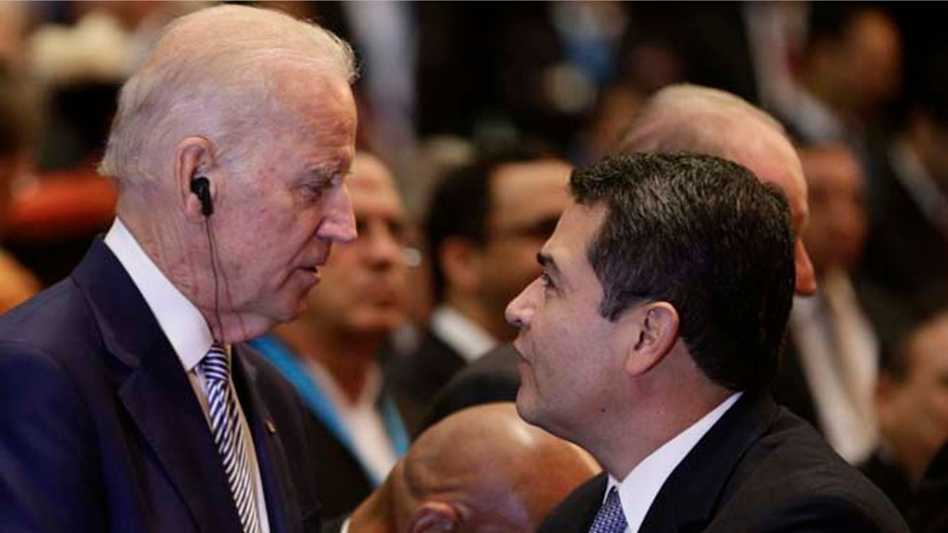 U.S. Vice President Joe Biden, center, talks with Honduras' President Juan Orlando Hernandez as Cuba's Vice President Salvador Valdes Mesa stands left, at the swearing-in ceremony for Guatemala's new President Jimmy Morales inside the National Theater in Guatemala City, Thursday, Jan. 14, 2016. The TV comic and political neophyte was inaugurated amid uncertainty over how he plans to run the Central American nation beset by entrenched poverty, corruption and violent criminal gangs. (AP Photo/Arnulfo Franco)