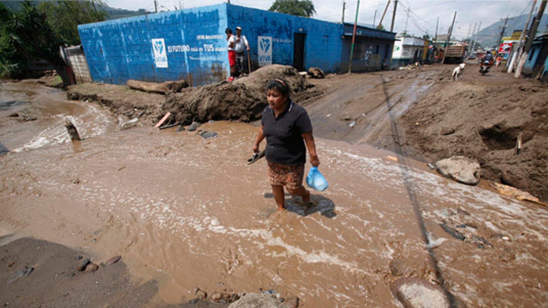 June 1: A woman crosses a flooded way after the Mico river overflowed due to heavy rains from tropical storm Agatha in Amatitlan, Guatemala. (AP)