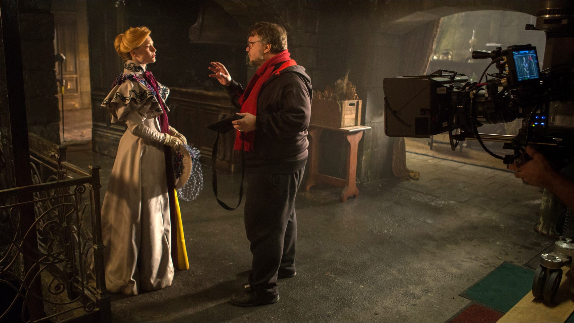 Actress Mia Wasikowska with director Guillermo del Toro on the set of "Crimson Peak."