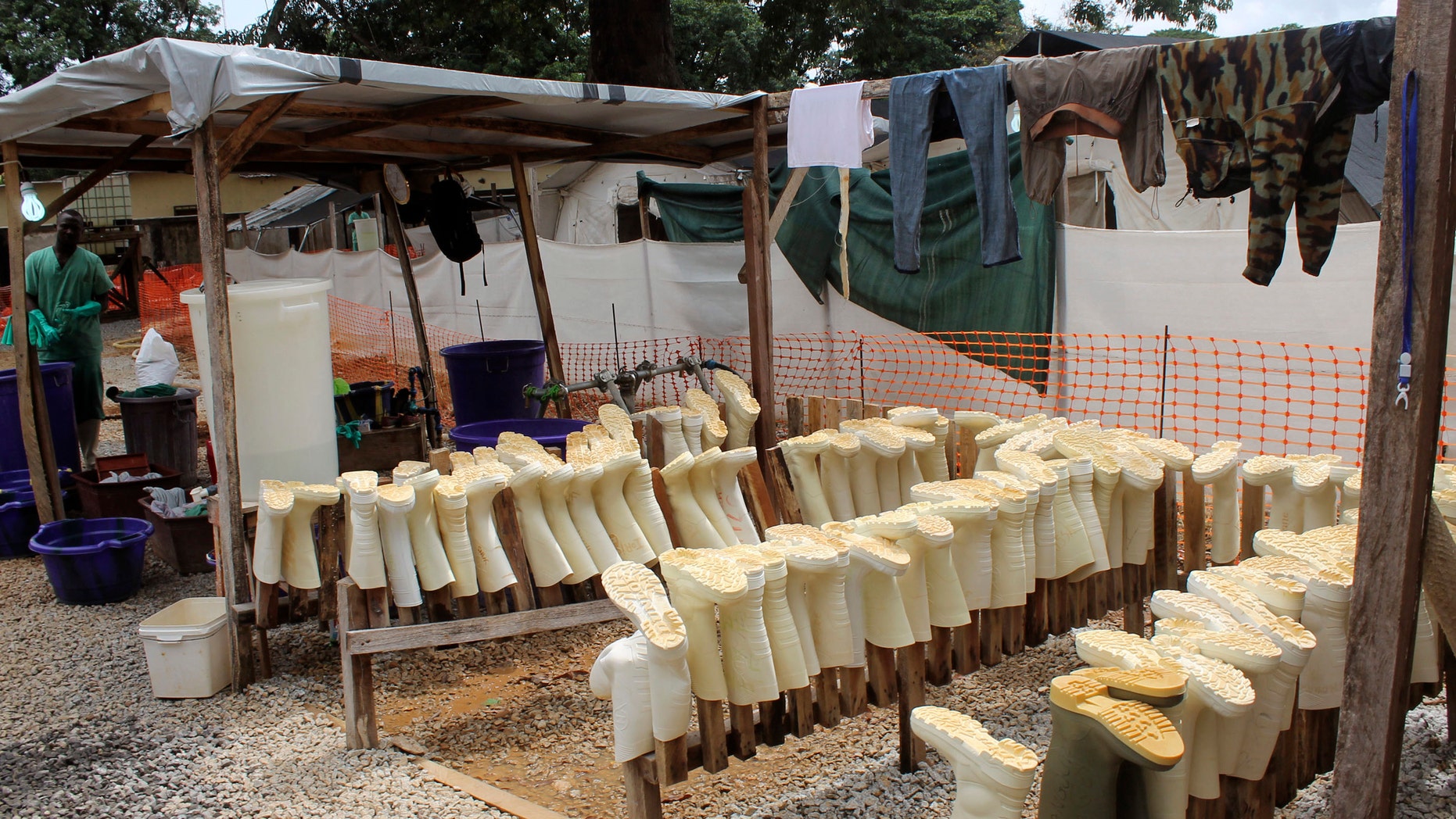 Aug. 20, 2014: In this photo, boots worn by health workers as part of their personal protective equipment are placed on racks to dry after they were washed at a Doctors Without Borders Ebola care center in Conakry, Guinea.