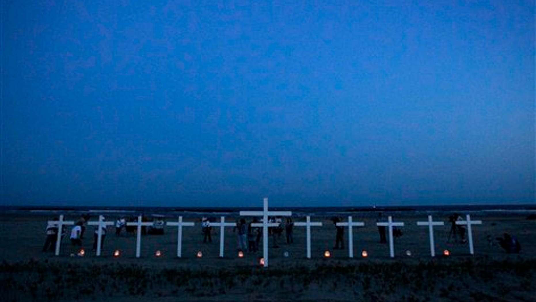 April 20: People gather near crosses -- 11 for the workers who died in the Deepwater Horizon oil rig explosion and one for the Gulf of Mexico on a beach in Grand Isle, La.