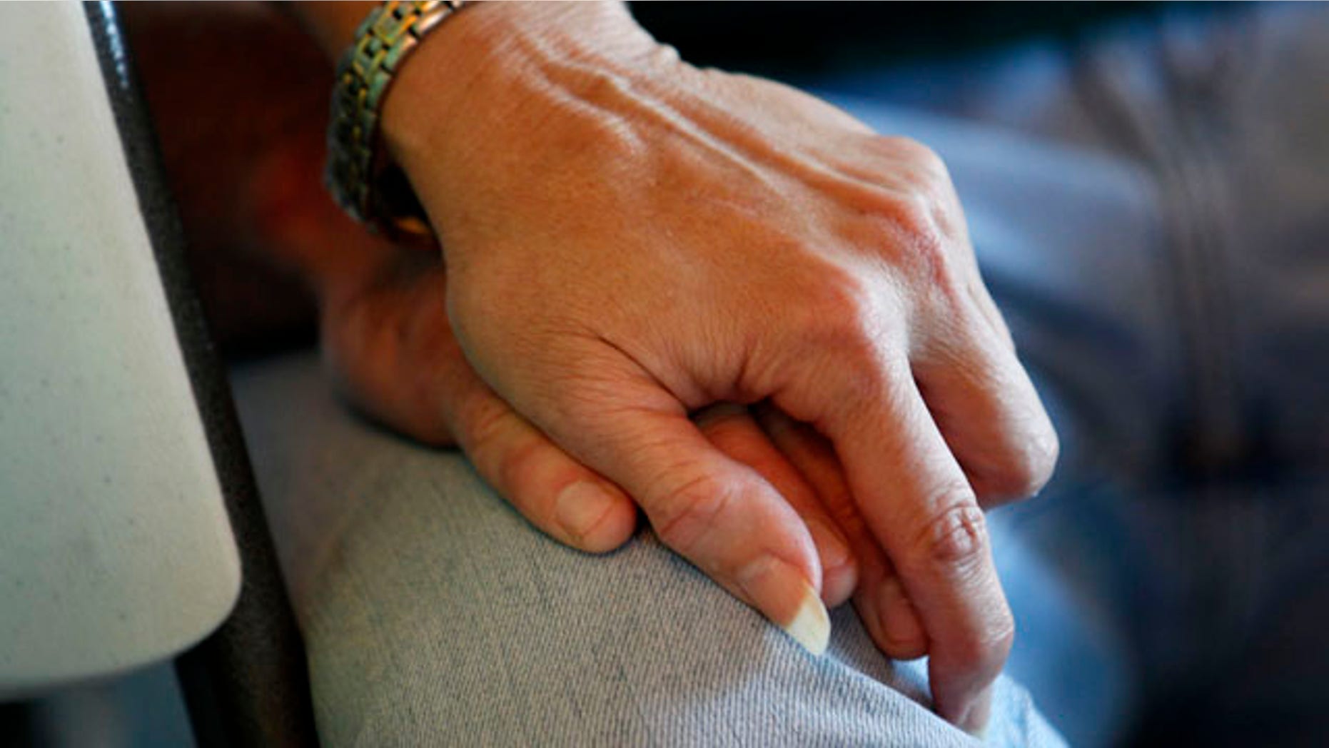 Nov. 11: Peggy Kemp, mother of Roy Wyatt Kemp, 27, holds the hand of her other son Sandon Kemp, 29, in Jonesville, La., while talking about Roy's life and death.
