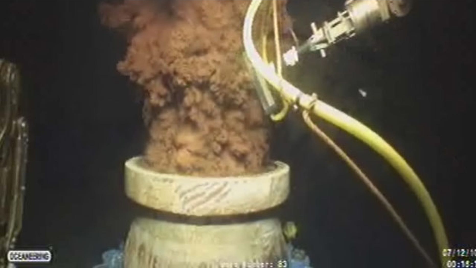 FILE - In this Monday July 12, 2010 image from video made available by BP PLC, oil flows out of the top of the transition spool, which was placed into the gushing wellhead and will house the new containment cap, at the site of the Deepwater Horizon oil spill in the Gulf of Mexico. (AP Photo)
