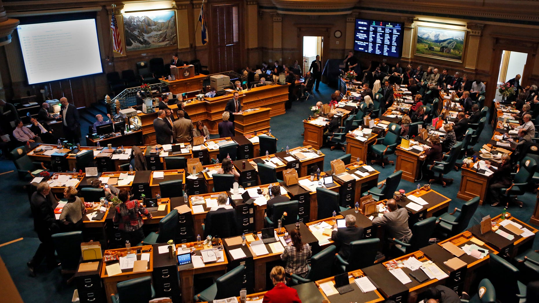 House members gather in their Chamber at the Capitol in Denver on Friday, Feb. 15, 2013, where a long emotional debate about guns and bills dealing with them is expected to last the entire day. Colorado lawmakers clashed Friday over setting limits on the size of ammunition magazines, a proposal in a package of Democratic bills responding to mass shootings at a suburban Denver movie theater and a Connecticut elementary school.(AP Photo/Ed Andrieski)