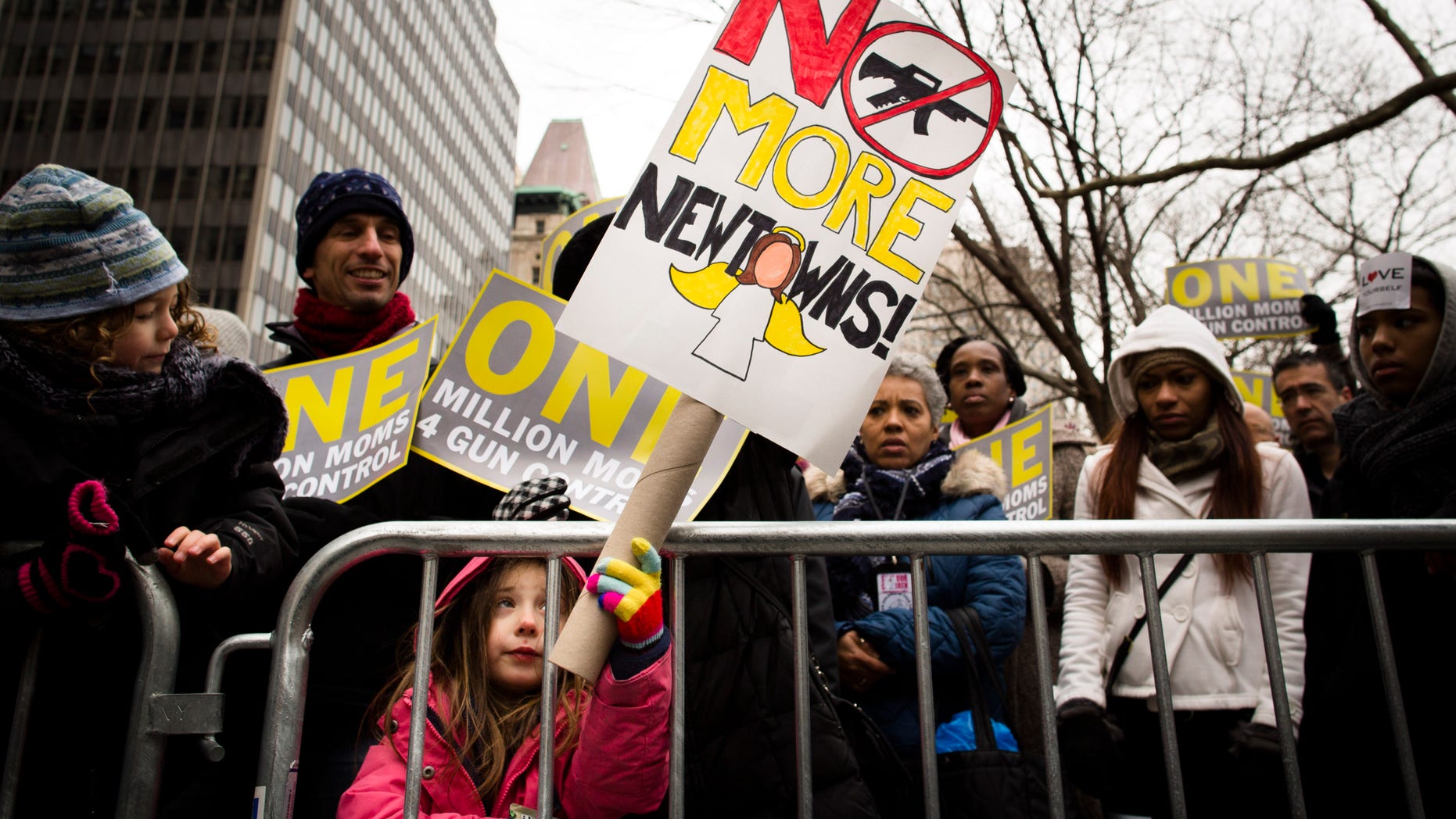 FILE - In this Jan. 21, 2013 photo, Emma Clyman, 5, of Manhattan, holds a sign that reads "No More Newtowns" outside city hall park during the One Million Moms for Gun Control Rally in New York. Despite a proposal backed by over 8 in 10 people in polls, gun control supporters are struggling to win over moderate Democrats in their drive to push expanded background checks of firearms purchasers through the Senate next month. (AP Photo/John Minchillo, File)