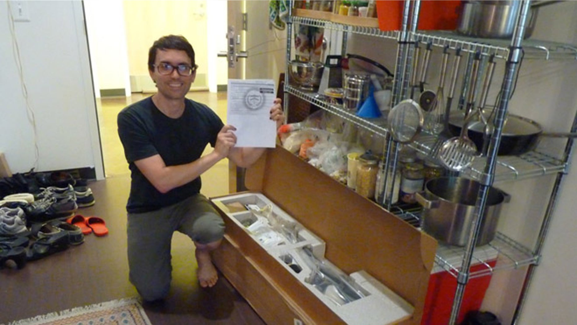 Aug. 7, 2012: This photo, taken in Washington, provided by Seth Horvitz, shows Horvitz, a musician who ordered a 39-inch flat screen television from Amazon, with a military-grade semi-automatic rifle he received in a shipping error.