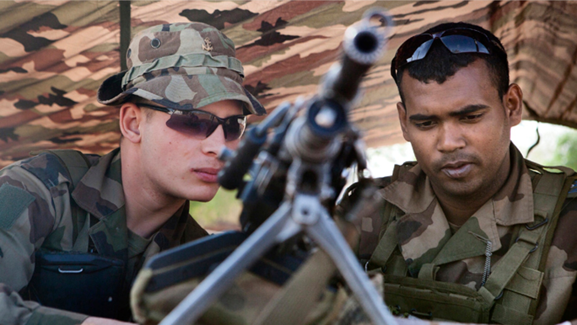 Jan. 26: French soldiers man a checkpoint at the French controlled area of the Bamako airport.