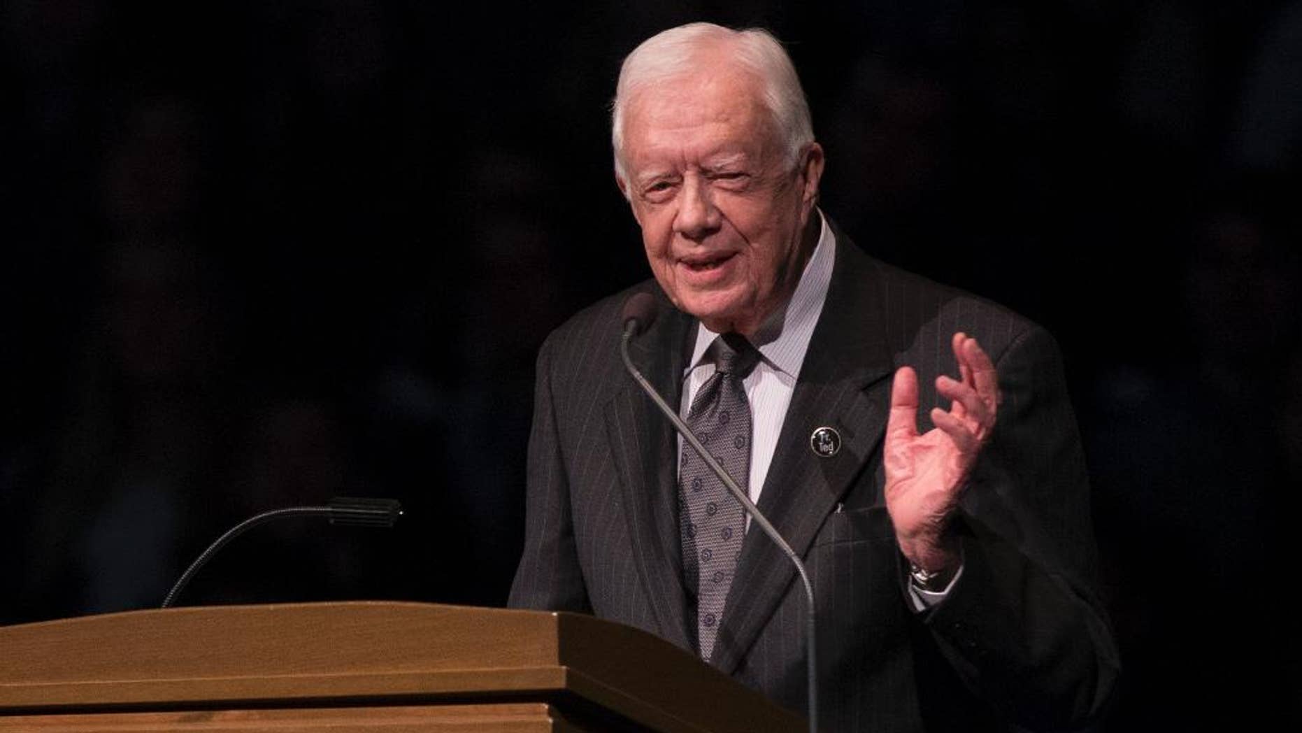 FILE - In this March 4, 2015, file photo, former President Jimmy Carter speaks during the memorial service for Rev. Theodore Hesburgh, inside the Purcell Pavilion at the University of Notre Dame in South Bend, Ind. Carter Center officials said Sunday, May 10, 2015, that the former President has cut short an election observation visit in Guyana due to health reasons. The statement from the Center says the 90-year-old ex-president is returning to Atlanta. It did not disclose specifics, only saying Carter was “not feeling well.”(AP Photo/Robert Franklin, File)