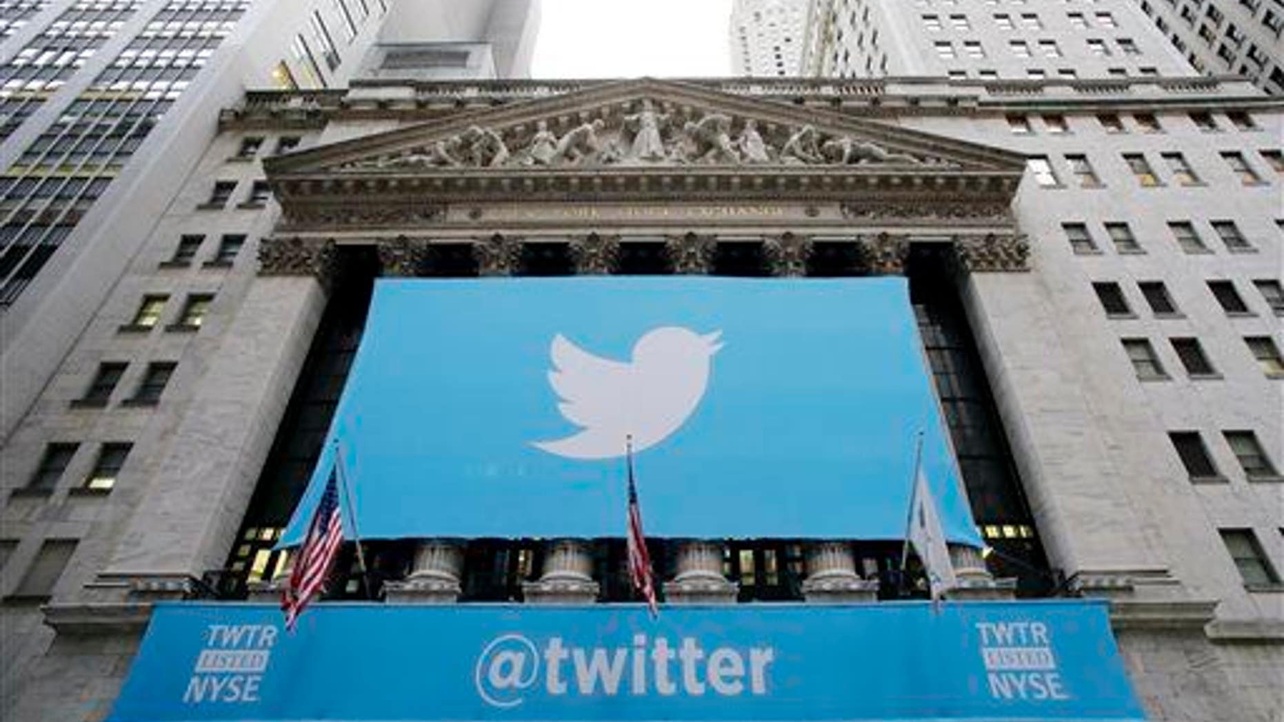 In this Thursday, Nov. 7, 2013 file photo, a banner with the Twitter logo hangs on the facade of the New York Stock Exchange.