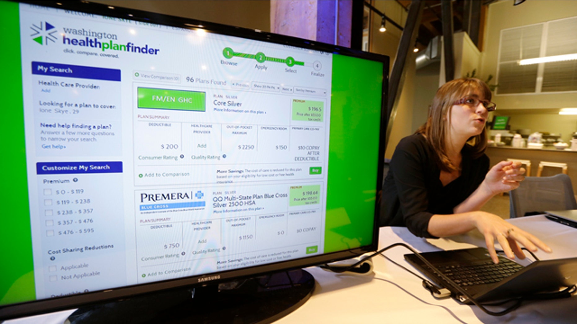 FILE - In this Sept. 30, 2013 file photo, Nelly Kinsella demonstrates the Washington Healthplanfinder website, in Seattle (AP Photo/Elaine Thompson, File)