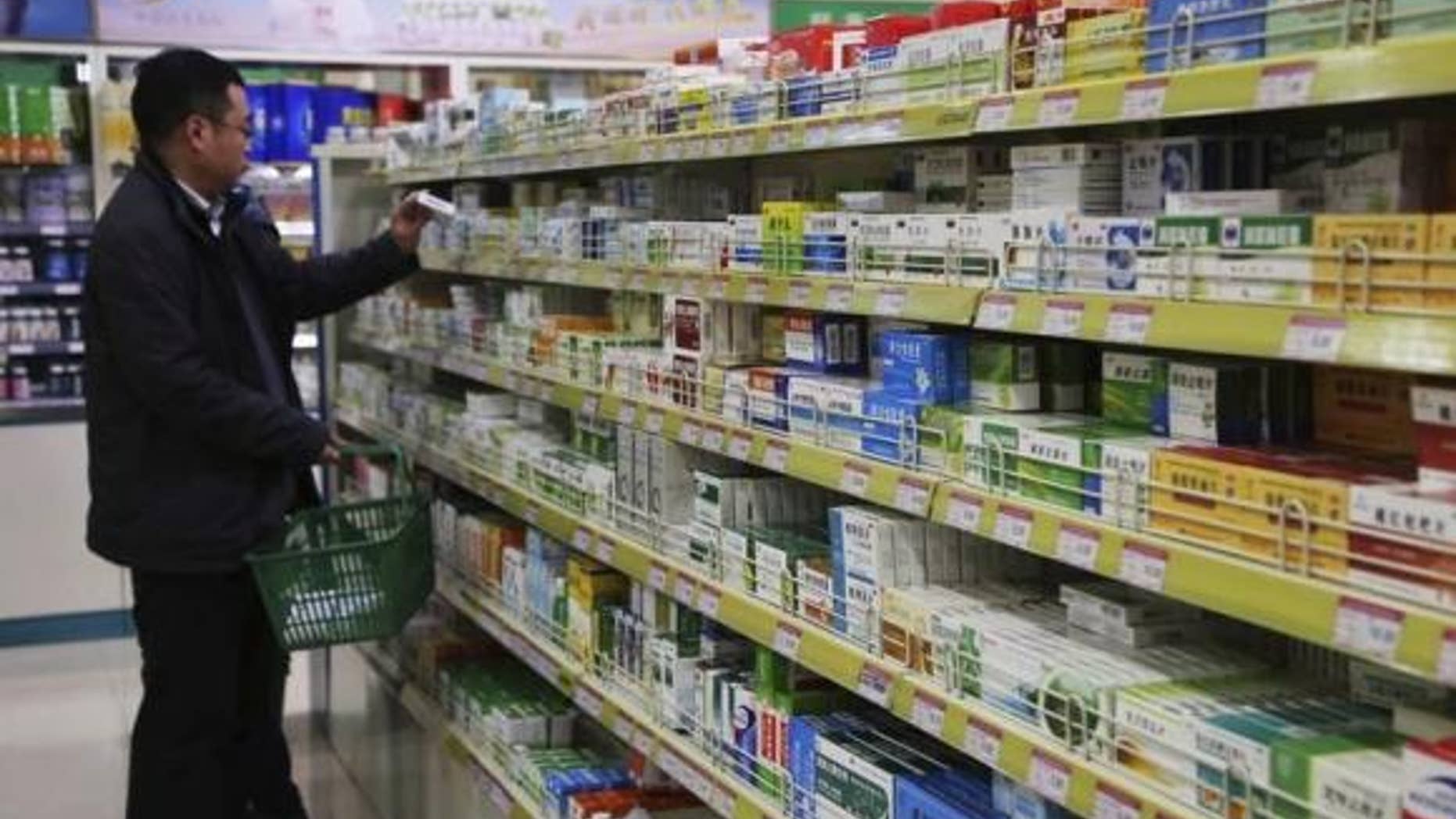March 8, 2014: A customer shops at a pharmacy in Xuchang, Henan province.