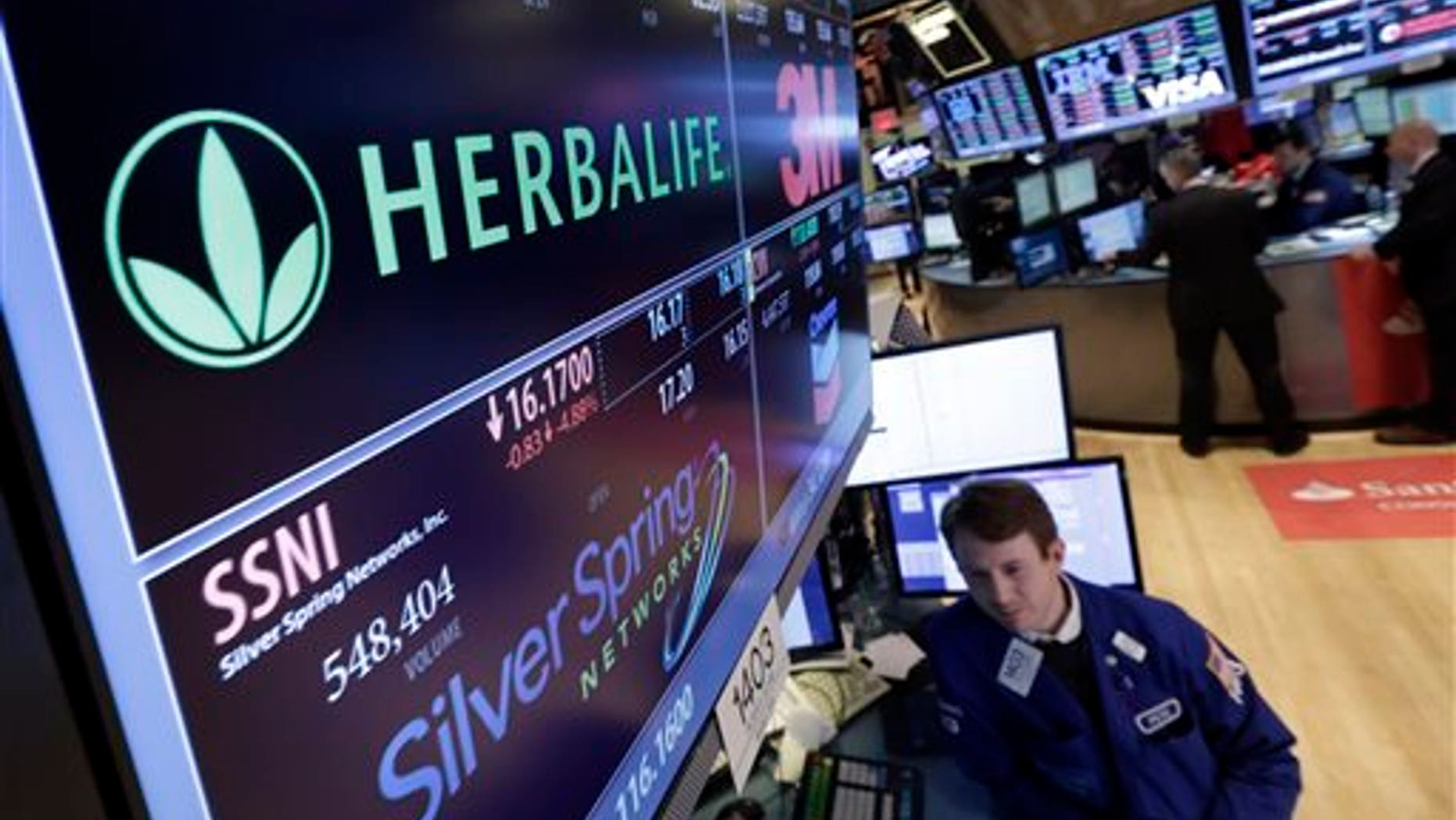 Specialist Peter Elkins foreground, works at the post that handles Herbalife, on the floor of the New York Stock Exchange, Thursday, Jan. 23, 2014. Herbalife Ltd. shares fell Thursday after U.S. Sen. Edward Markey called for an investigation into the company's business practices. (AP Photo/Richard Drew)