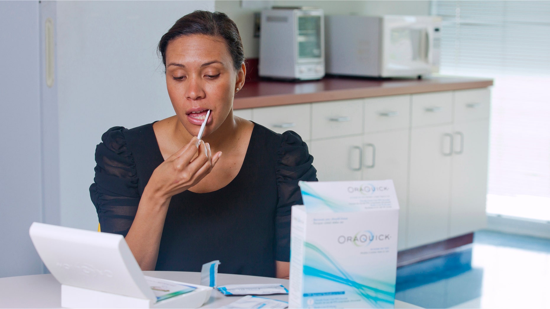 In this undated handout photo provided by Orasure a model demonstrates the OraQuick test, which detects the presence of HIV in saliva collected using a mouth swab. The test is designed to return a result within 20 to 40 minutes. The U.S. Food and Drug Administration approved the first over-the-counter HIV test Tuesday, July 3, 2012, allowing Americans to check themselves for the virus that causes AIDS in the privacy of their homes. (AP Photo/Orasure, Chuck Zovko)