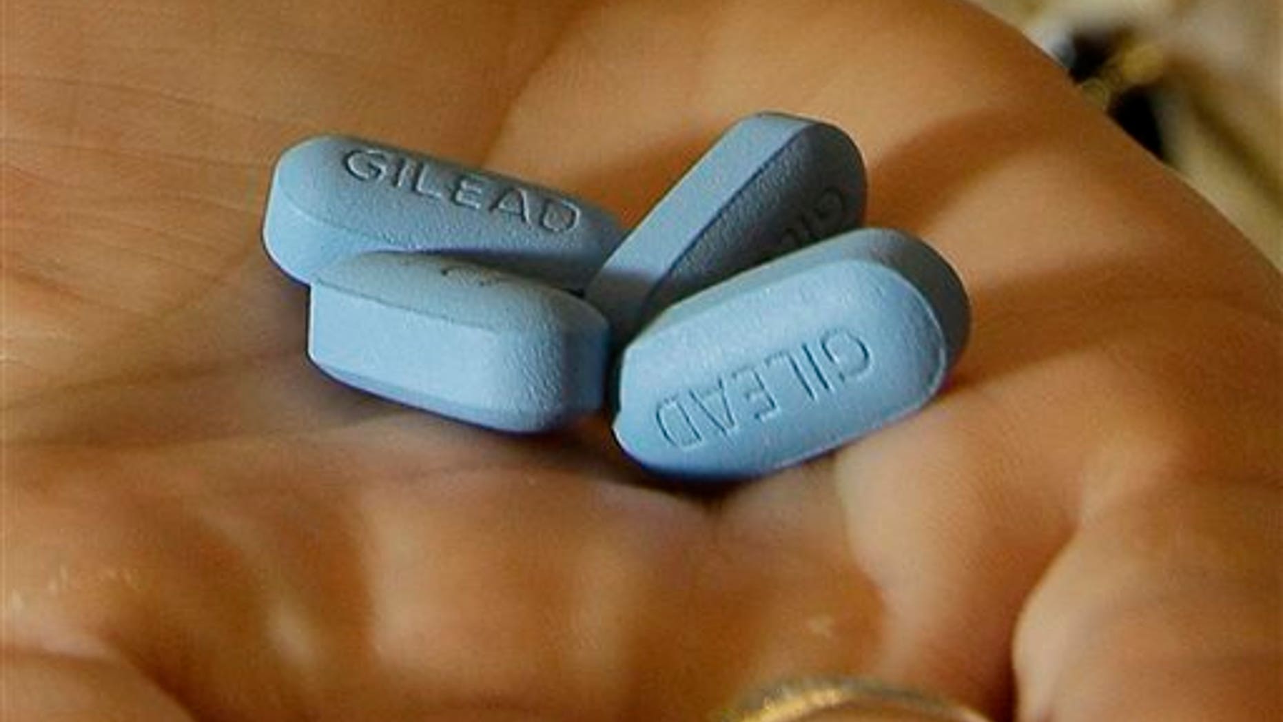 In this Thursday, May 10, 2012 file photo, a doctor holds Truvada pills at her office in San Francisco. (AP Photo/Jeff Chiu)