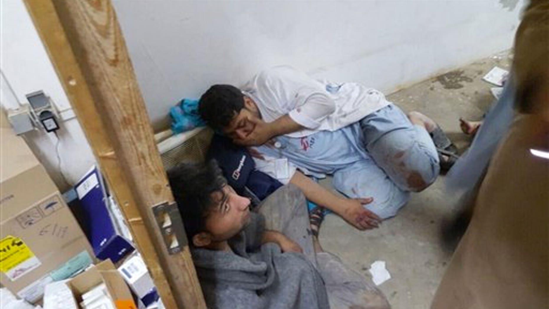 Injured Doctors Without Borders staff are seen after explosions near their hospital in the northern Afghan city of Kunduz, Saturday, Oct. 3, 2015. (Médecins Sans Frontières via AP)
