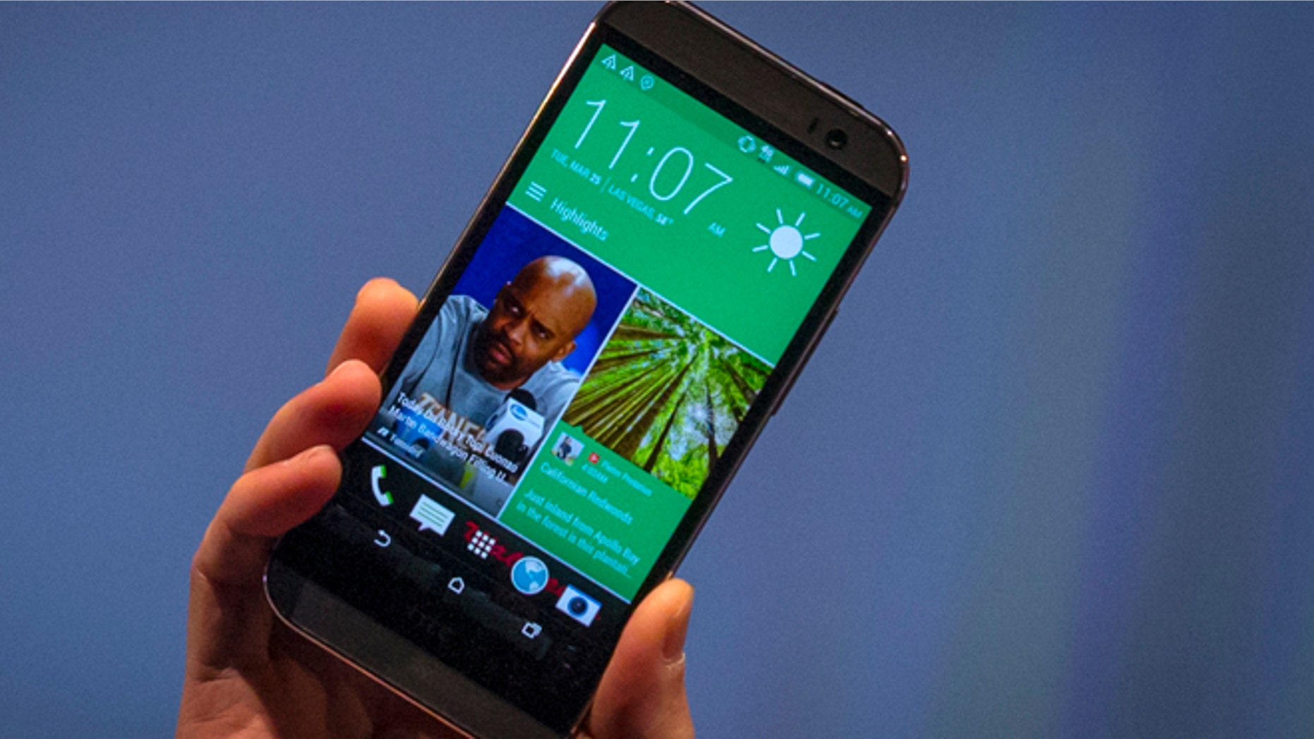 March 25, 2014: HTC CEO Peter Chou shows the new HTC One M8 phone during a launch event in New York.