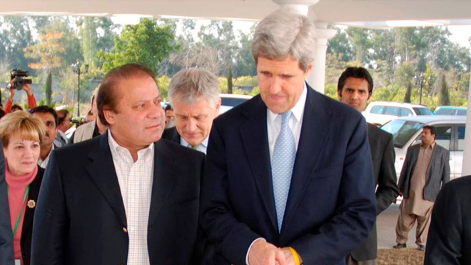 FILE: Feb. 18, 2008: Sen. John Kerry and former Pakistan Prime Minister Nawaz Sharif followed by then-Sen. Chuck Hegel in Raiwand, Parkistan.