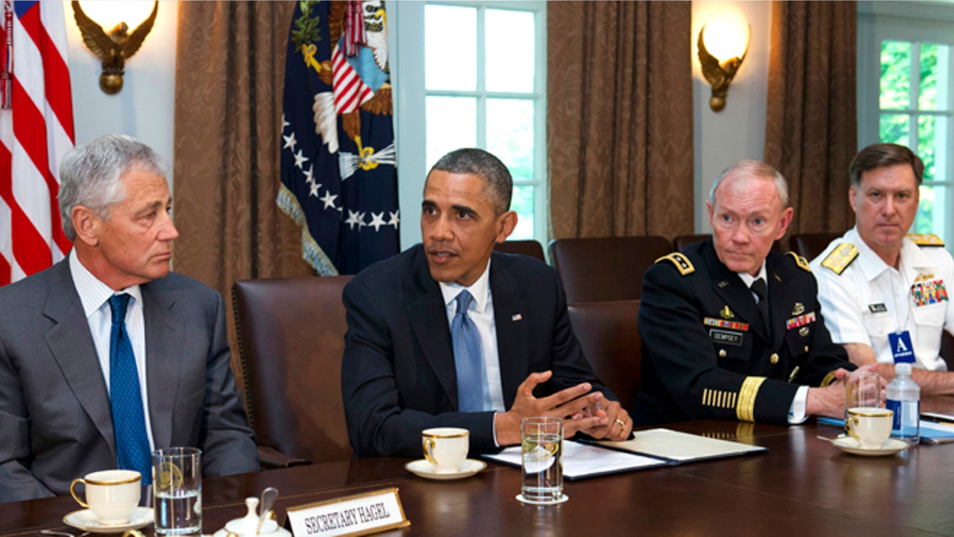 FILE: May 16, 2013: Defense Secretary Chuck Hagel, left, listens to President Obama, next to Joint Chiefs Chairman Gen. Martin Dempsey, and Vice Chief of Naval Operations Adm. Mark Ferguson, in Washington, D.C.