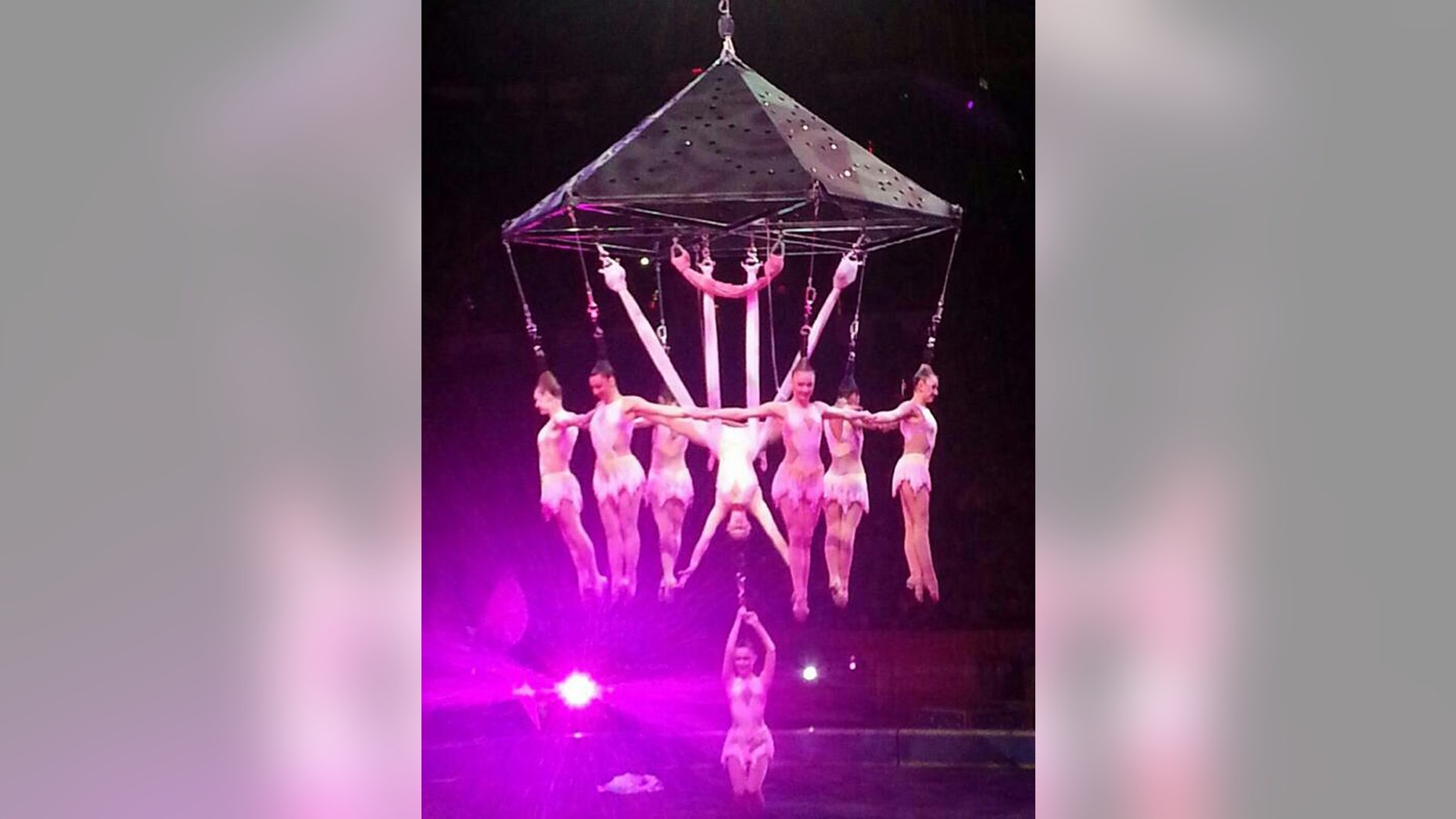 In this photo provided by Frank Caprio, performers hang during an aerial hair-hanging stunt at the Ringling Brothers and Barnum and Bailey Circus, Friday, May 2, 2014, in Providence, R.I. A platform collapsed during an aerial hair-hanging stunt at the 11 a.m. performance Sunday, May 4, sending eight acrobats plummeting to the ground. At least nine performers were seriously injured in the fall, including a dancer below, while an unknown number of others suffered minor injuries. (AP Photo/Frank Caprio) MANDATORY CREDIT