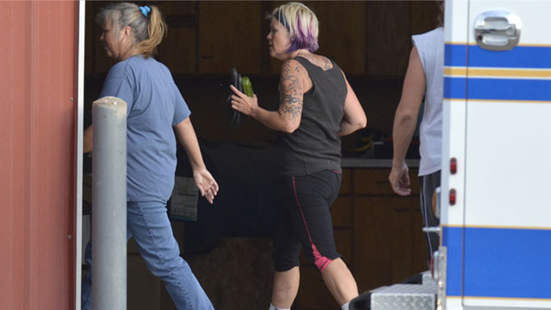 August 25, 2013: This photo provided by the Imperial Republican shows kidnapping victim Julie Hanes, 38, of Lincoln after being released by her abductor and estranged husband in a massive manhunt for the pair. She is accompanied by Imperial EMS after being brought safely to the police staging area northwest of Imperial.(AP Photo/Imperial Republican, Russ Pankonin)