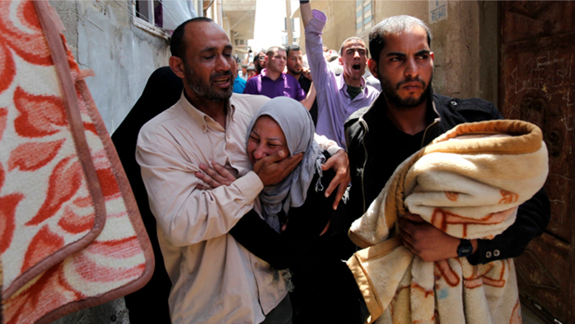 April 30, 2013: Palestinian relatives of Haitham Mishal, 29, react during his funeral in the Shati Refugee Camp in Gaza City. An Israeli aircraft attacked a motorcyclist in Gaza on Tuesday, killing the rider and wounding two other people in the first deadly airstrike in the Palestinian territory since a truce was reached with Palestinian militants last November. The Israeli military said the airstrike killed Haitham Mishal, whom it identified as a militant involved in the April 17 rocket attack on the southern Israeli resort town of Eilat.