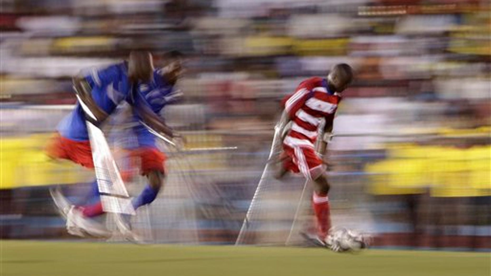 Jan. 10, 2011: A player belonging to Haiti's unofficial national amputee soccer team, right, controls the ball as two players from the local Zaryen team attempt to defend in a friendly match at the national stadium in Port-au-Prince, Haiti. The game is one of many events planned to mark the one-year anniversary of the Jan. 12th magnitude-7.0 quake that killed more than 220,000 people and left millions homeless. Many of the players from both teams lost their limbs in the earthquake. (AP)