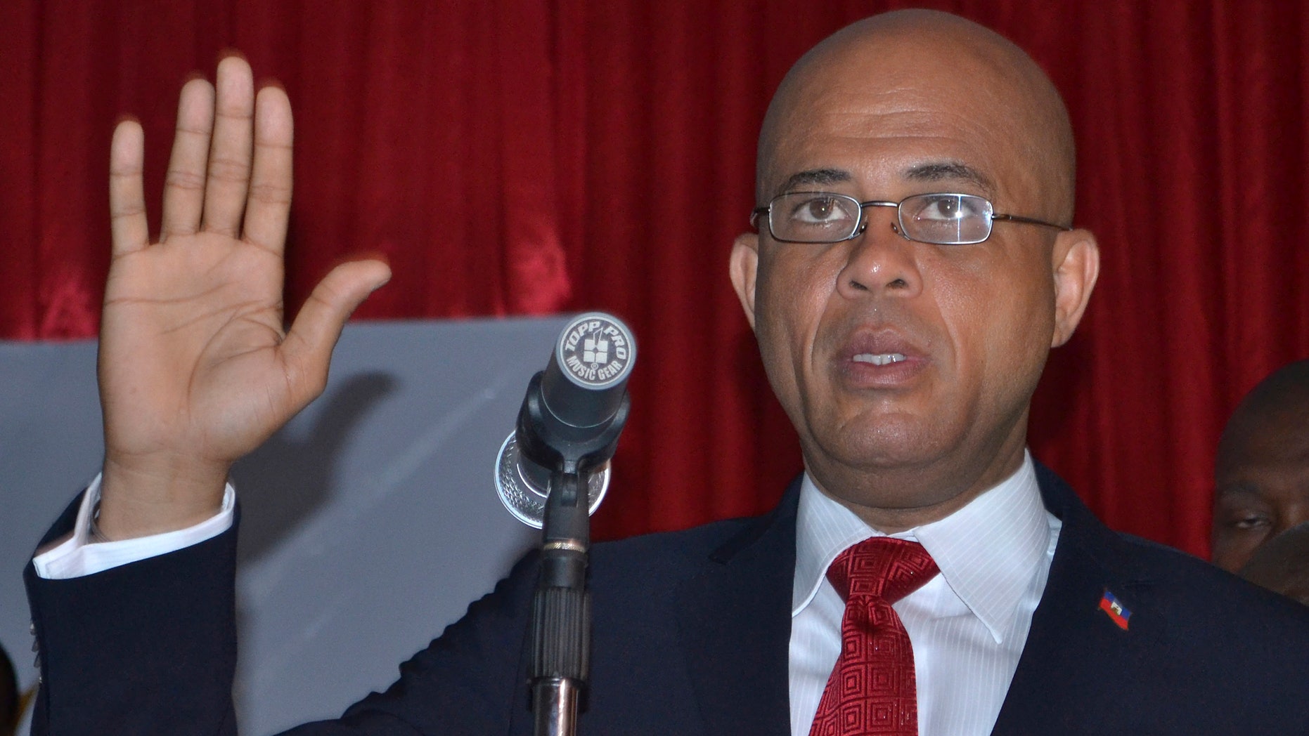 Michel Martelly is sworn in as Haiti's new president inside a Haitian Parliamentary meeting room in Port-au-Prince, Haiti, Saturday May 14, 2011. Martelly, better known as the popular singer "Sweet Mickey, defeated his closest rival former, first lady Mirlande Manigat, in a landslide victory with 67.5 percent of the vote in the runoff elections held on March 20th.