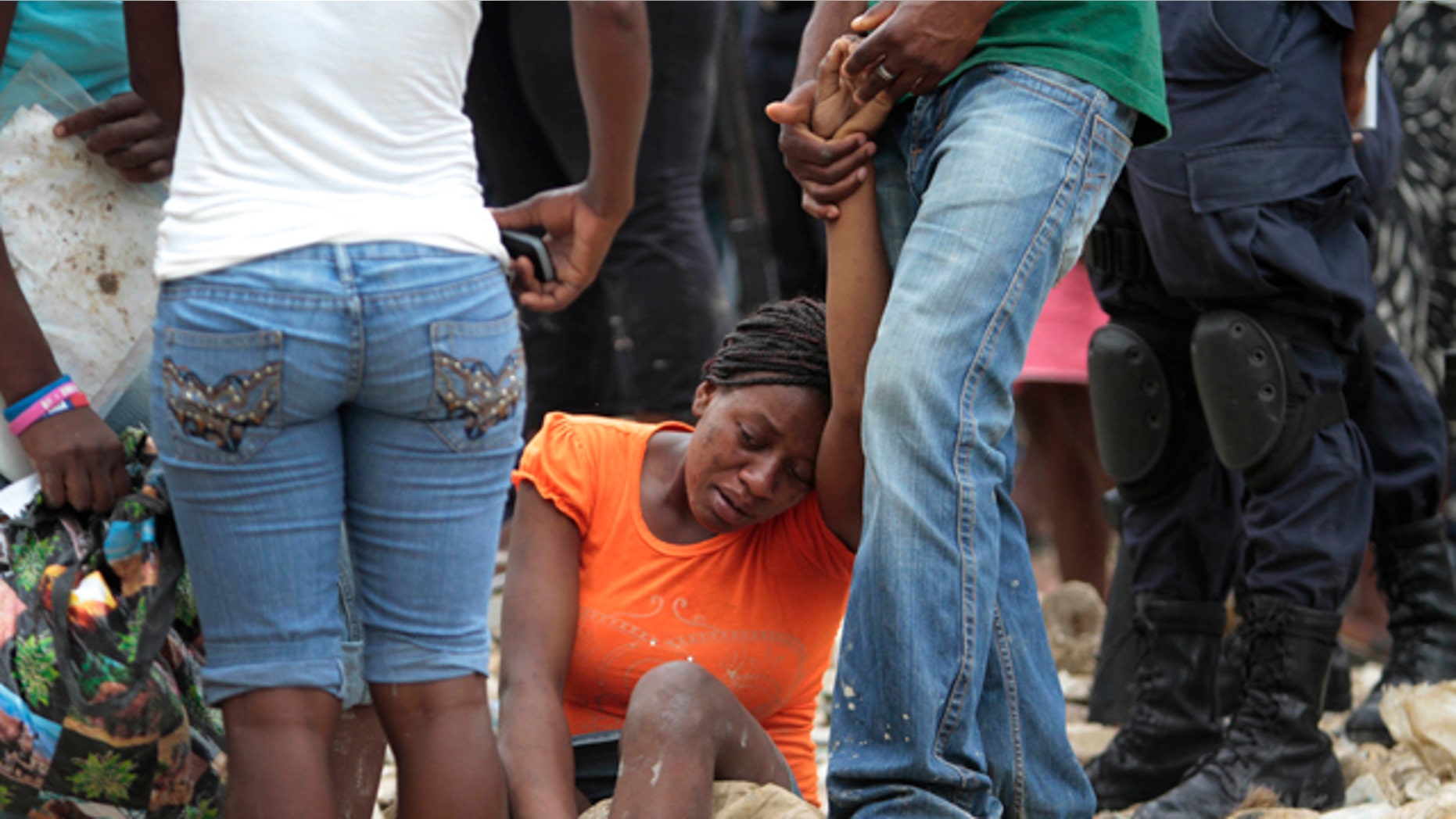 June 7: A woman reacts at the site of a deadly landslide in Port-auPrince, Haiti. Heavy rain hammered southern Haiti for a seventh straight day on Tuesday, triggering floods and mudslides and causing houses and shanties in the capital to collapse.