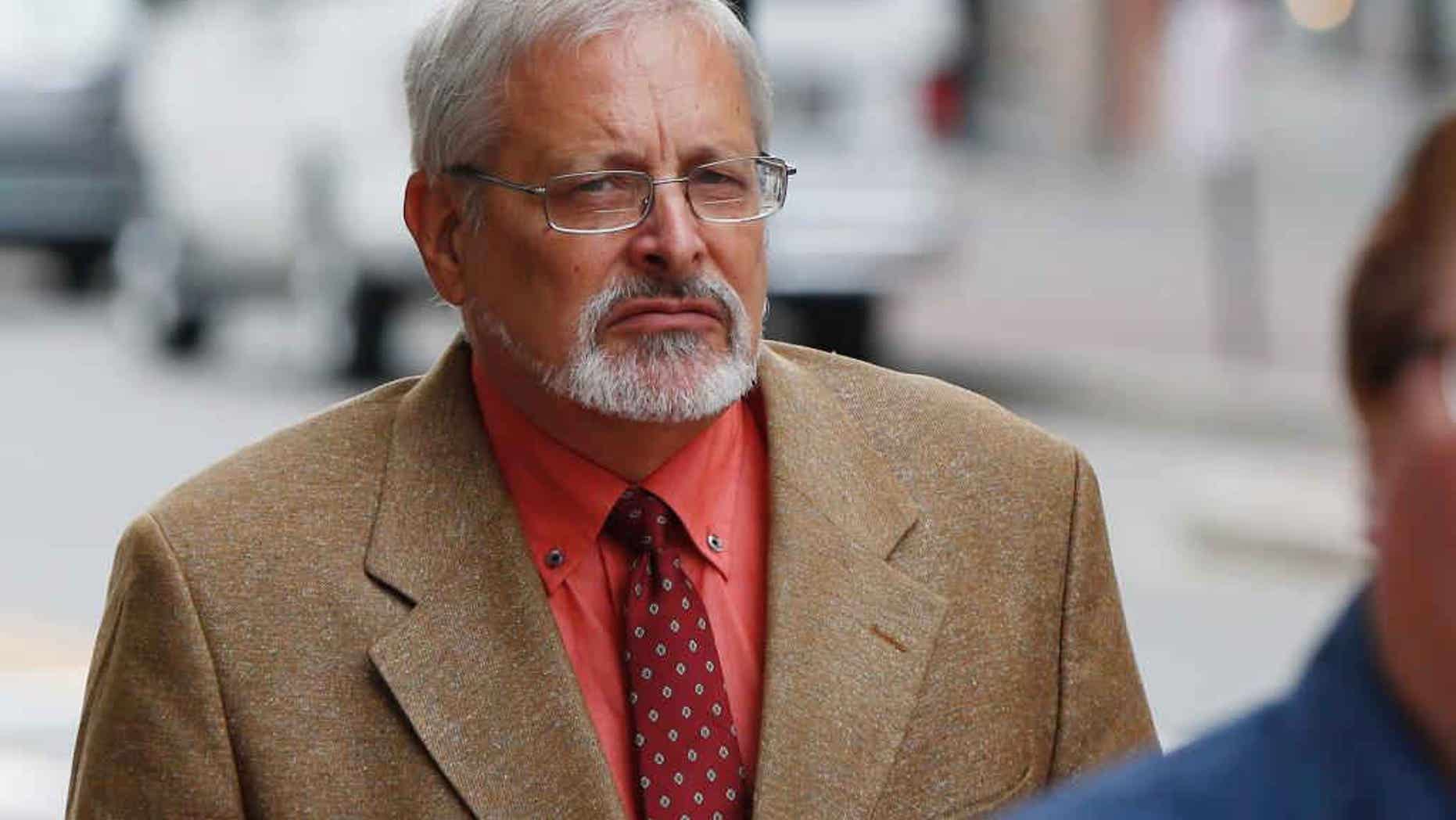 FILE - In this July 9, 2015 file photo, Michael Geilenfeld arrives at U.S. Bankruptcy Court, in Portland, Maine. Geilenfeld who founded a Haiti orphanage for boys was back in the Caribbean country on Wednesday, July 29, 2015, after a U.S. jury ordered an activist to pay $14.5 million in damages for falsely accusing him of sexually abusing children in his care. Geilenfeld's said the orphanage founder feels “very happy and vindicated” by the jury's verdict in Maine and is looking forward to resuming his work in the impoverished nation. (AP Photo/Robert F. Bukaty, File)